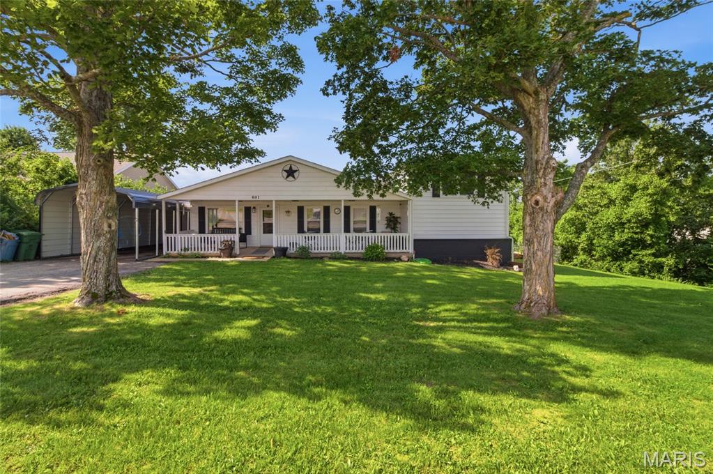 Welcome home to this beautifully maintained 3-bedroom, 2-bath residence in the heart of Rolla, offering the perfect blend of comfort, functionality, and pride of ownership. From the moment you arrive, you'll appreciate the care and attention that has gone into keeping this home in exceptional condition. Inside, the warm and inviting layout creates an ideal space for both everyday living and entertaining. The kitchen serves as the heart of the home, featuring a stylish tile backsplash that adds character and charm while complementing the surrounding workspace. Downstairs, the spacious lower-level family room offers the perfect retreat for relaxing evenings, complete with a cozy fireplace that creates a welcoming atmosphere year-round. Step outside and discover even more room to enjoy. The oversized carport provides ample covered parking and convenience, while the impressive 12x20 storage outbuilding with electric offers endless possibilities for hobbies, a workshop, extra storage, or project space. Recent updates, including a brand-new roof installed in 2025, provide added peace of mind for years to come. Conveniently located near schools, shopping, dining, and everything Rolla has to offer, this move-in-ready home combines practical features with comfortable living in a well-established setting. Don't miss your opportunity to own this exceptionally clean and well-cared-for property—schedule your private showing today and see all that this wonderful home has to offer!