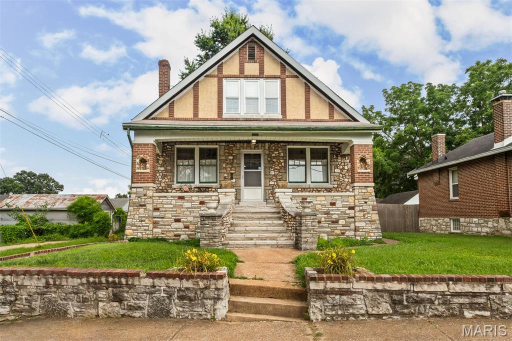 Welcome to 7920 Hildesheim, this home is a beauty,  spectacular curb appeal with huge brick and stone front porch.  Enter into living room with decorative fireplace, take note of wood floors and gorgeous stain glass windows in both living and dining rooms. Updated eat in kitchen with loads of cabinets and a breakfast bar island. The main floor bedroom and full bath complete the main level.  Upstairs are 2 nice size bedrooms both with walk-in closets and a half bath.  The walk out basement is wide open with plenty of storage area, laundry and lots of room to finish if you need room to grow.  Out back is a level yard and 2 car garage.  This home has been well maintained through the years and is ready for a new owner.  Super convenient location, make an appointment to see for yourself, you'll be glad you did.