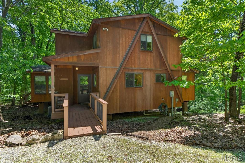 Welcome to 2630 Grendel Drive!  Built in 2010 this chalet is nestled on a private, wooded 2-acre lot at Innsbrook Resort. This serene retreat features cedar-paneled interiors, a private deck, and a fire pit that perfectly complement the tranquil, treehouse-like setting. Step inside to an open-concept layout with a fully equipped kitchen offering counter seating, seamlessly flowing into the vaulted great room. Floor-to-ceiling windows flood the space with natural light and frame stunning woodland views — all enjoyed from the comfort of a cozy wood-burning fireplace. A separate dining area provides ample space for hosting family and friends. A rare find at Innsbrook, this home offers four bedrooms — two on the main level including the primary suite, and two additional bedrooms plus a full bath and a sleeping loft upstairs. Thoughtfully insulated for year-round use, the home also includes a dishwasher, washer/dryer, and connection to sewer. Offered mostly furnished, this turnkey property is ideal as a weekend getaway, or income-producing rental — currently listed on Airbnb. Enjoy access to Innsbrook’s extensive amenities, including a recreation complex with a pool, fitness center, tennis and pickleball courts, an amphitheater, Summerhaus, scenic nature trails, over 100 lakes, equestrian stables, an 18-hole championship golf course, Clubhouse dining, Camp Innsbrook, and more — all with the convenience of back gate access to this chalet. New HVAC Dec 2025.