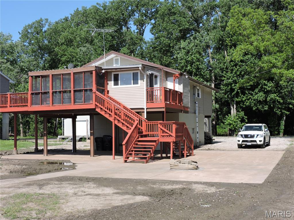 LOOK AT THAT STUNNING RIVER VIEW!!!!   Welcome to your very own water front home on the Mississippi river!!!   One of the larger homes around consists of 3 bedrooms (MBR has MB), an eat-in kitchen w/granite countertops, dining room, living room, 2 1/2 bathrooms, covered screened in porch, 3 elevated decks, basement garage with 1/2 bath, approx. 18 X 18 floating metal shed with workshop, 2 slip boat dock (1 covered), swim dock, concrete patio with firepit. Central heat and air.  Electric deck hoist, electric fireplace.  Home has updated metal roof, windows, soffit/gutters, vinyl laminate and carpet. Owner wishes to sell furnished.   Cast a line into the river from your very own seawall. Load the kids in the boat and head to the sandbar for an afternoon of swimming, volleyball, bbqing or just hanging out. Bring your atv to ride the numerous trails in the area.    Close to Cannon wildlife area and BK Leach area offering hunting and rec. Suitable for VRBO