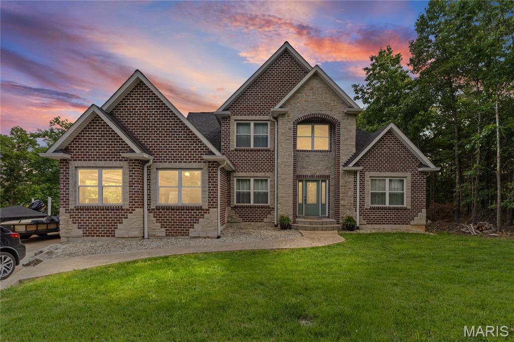 Welcome to 5604 Katys Way in the highly sought-after Raintree Plantation community! This spacious custom home offers over 3,500 square feet of beautifully designed living space with 5 bedrooms and 3.5 bathrooms, perfectly blending comfort, style, and functionality.

Step inside to soaring vaulted ceilings, an open-concept floor plan, and abundant natural light throughout. The heart of the home features a large entertainer’s kitchen with ample cabinetry, generous counter space, pantry storage, and seamless flow into the dining and living areas. Cozy up by the fireplace or enjoy peaceful wooded views from the back deck.

The spacious primary suite offers a relaxing retreat with a large en-suite bath, while the finished walk-out lower level provides additional living space ideal for guests, recreation, or a home office setup.

Situated on a private lot backing to trees in the gated Raintree Plantation community, residents enjoy resort-style amenities including multiple lakes, golf course, country club, pool, beach, boating, fishing, tennis courts, and more.

If you’ve been searching for space, privacy, and lake community living all within commuting distance to St. Louis, this is the one!