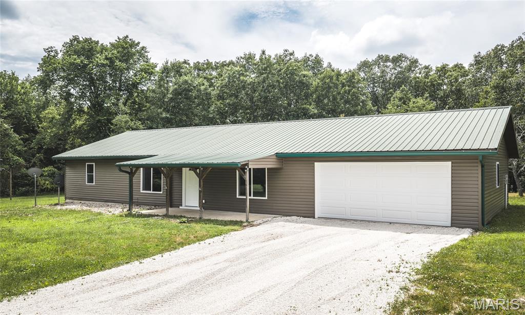 Spring Bluff lovers, this one is for you! Move right into this beautifully renovated 3-bedroom, 2-bath home offering over 2,300 square feet of living space on 7 scenic acres. Tucked back off the road for added privacy, this property combines modern updates with country charm. Inside, you'll find spacious living areas, a large laundry room, and a cozy wood-burning stove. Outside, the oversized garage and detached shop with concrete floors and electricity provide plenty of space for hobbies, equipment, or storage. There's even an old chicken coop ready for a little TLC and your homestead dreams. If you've been looking for acreage, privacy, and a move-in ready home in Spring Bluff, this is a must-see!
