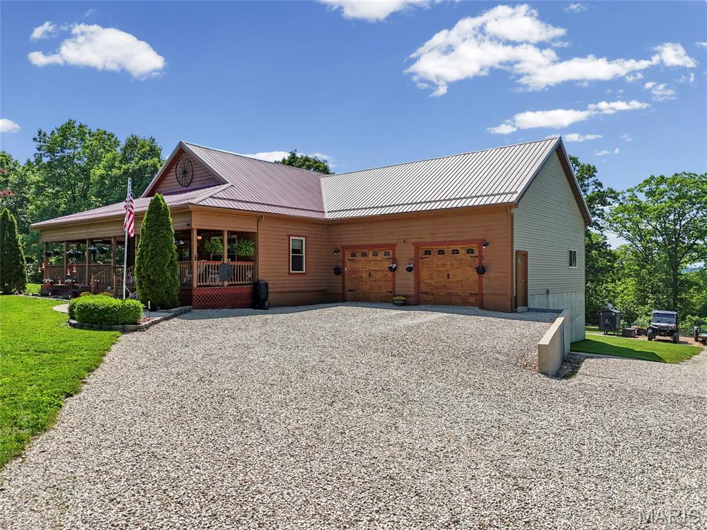 Tucked away on 11.2 stunning acres bordering Onondaga State Park, this custom-built rustic retreat offers the perfect mix of privacy, recreation, and modern comfort. Located less than a mile from the river and surrounded by incredible wildlife, you’ll regularly spot deer, turkey, and even bears right from your own property. Whether you’re looking for a full-time residence, weekend getaway, hunting retreat, or income-producing Airbnb, this property is set up to do it all.

The beautifully finished tongue-and-groove home features over 3,500 square feet with 3 bedrooms and 3 full baths, plus a fully equipped walkout basement complete with its own kitchen, separate entrance, and privacy door separating the upper and lower levels — ideal for guests, multi-family living, or short-term rental opportunities. A loft game room with wet bar adds even more entertaining space.

Major updates and upgrades provide peace of mind, including a new 50-year metal roof installed in 2024, windows replaced 3 years ago with transferable warranty, all new appliances, upgraded LED lighting throughout, and insulated garage doors replaced within the last 3 years. The home is exceptionally efficient with three heating sources including propane, electric, and a HeatMaster 5000 outdoor boiler system.

Outside, enjoy a small pond, fenced pasture with electric fencing, landscaped yard, and room for hobby farming or animals. The oversized garage is perfect for outdoor enthusiasts and storage alike. Equipment and select furnishings are negotiable, making this a true turnkey opportunity.

If you’ve been searching for a private Ozark getaway bordering thousands of acres of public land with endless recreation nearby, this property deserves a serious look.