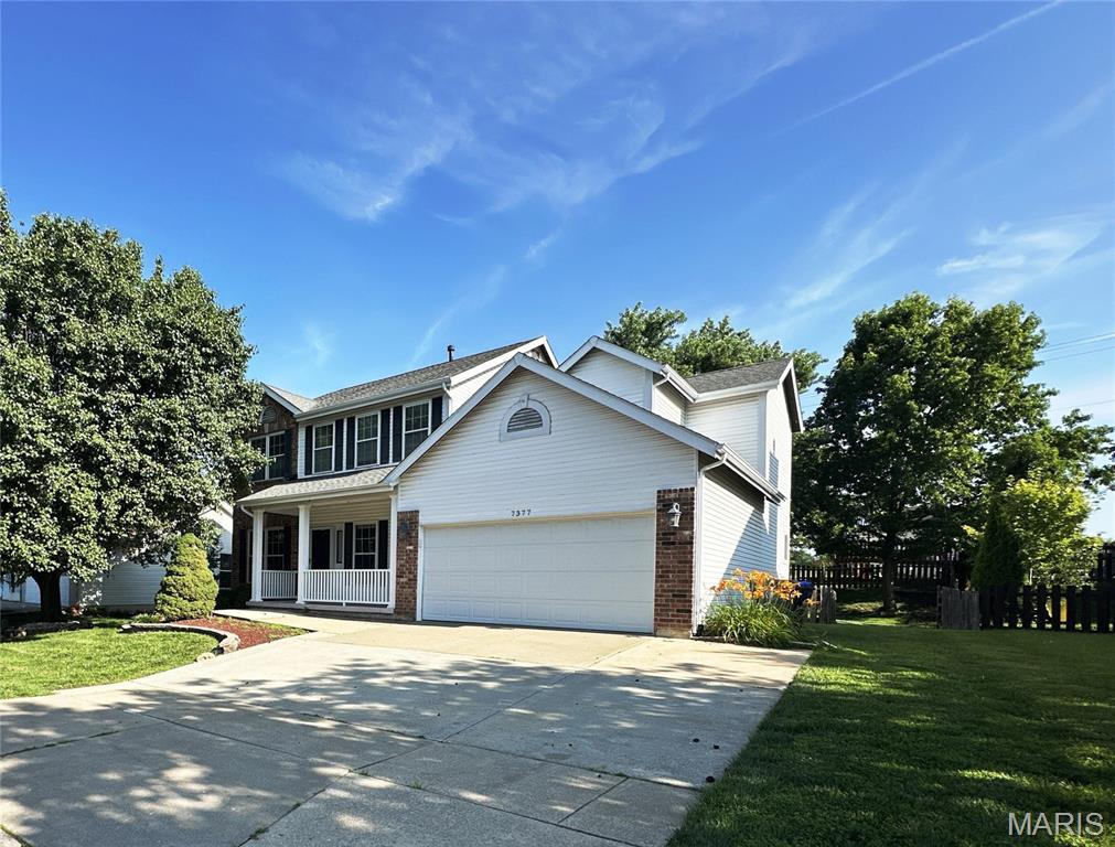 Spacious two-story home with an attached two-car garage provides three levels of living space. Interior features include: hardwood flooring, vaulted ceilings, panel doors, gas fireplace, bay window, vinyl siding, and a finished lower level. The main level includes separate living and dining rooms, a family room with fireplace, powder room, and a kitchen with adjoining breakfast area. The kitchen is upgraded with 42-inch cabinetry, granite countertops, a center island, and stainless steel appliances, providing ample workspace and storage.  The upper level features four bedrooms, including a primary suite with a private full bath, plus an additional full bathroom to accommodate the remaining bedrooms. The finished lower level space includes a recreation room, office or flex space, and additional storage area. Outdoor living includes a rear patio, while the attached two-car garage provides convenient parking and additional storage. Conveniently located near schools, shopping, restaurants, parks, and major commuter routes, this home offers a practical floor plan with flexible living spaces suitable for a variety of needs. Easy to show, set your appointment today!  Some photos virtually staged