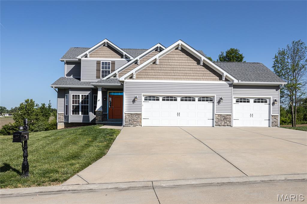 No need to buy new, in established neighborhood. Close to highway & Wentzville.
Newer, Troy South School District. Large level lot w/ expansive concrete driveway & oversized 23x35x10ft garage w/ 8ft doors with workshop space. Covered front porch with grand foyer entrance into vaulted great room w/open spindle above to secondary bedrooms w/ walk-in closets & plenty of storage. Main floor master w/separate deep tub, shower, walk-in closet & office space nook. 16 ft floor to ceiling, stone wood burning fireplace & wall of windows in spacious great room attached to open dining room kitchen concept for entertaining. Breakfast bar for additional seating, walk-in pantry & easy access to future deck. Nice layout for easy future finish w/ possible 4th bedroom, full bath, and lower level access with expansive 39x14ft patio to private land ideal for future pool! Welcome Home.