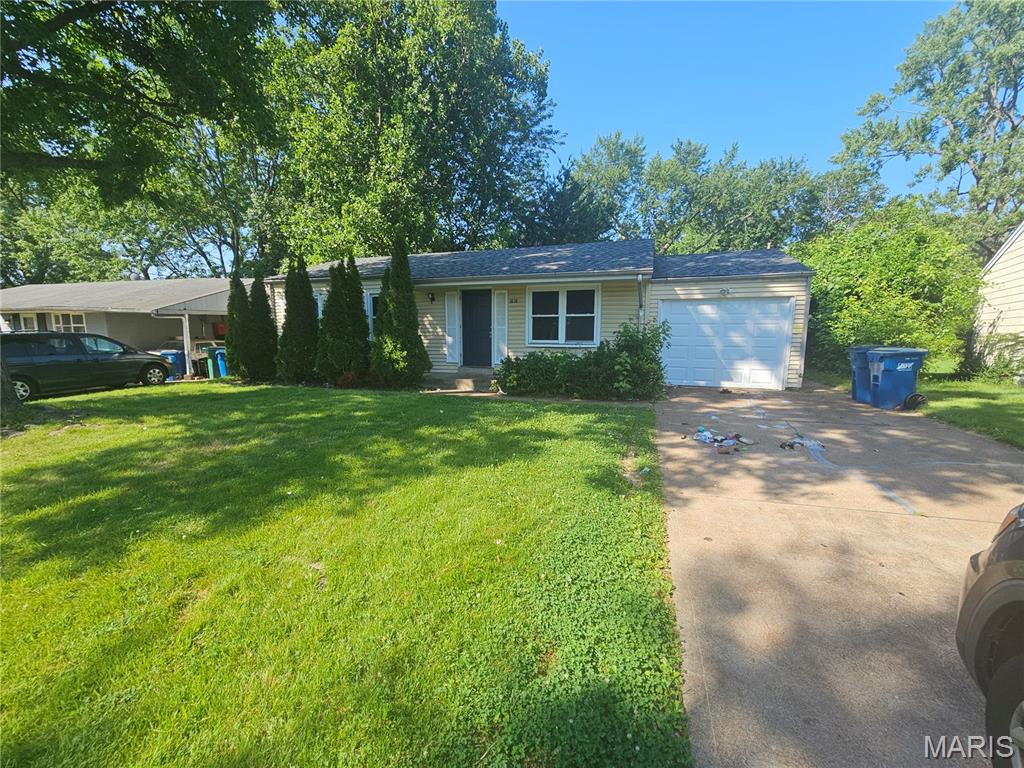 Welcome home to this charming 3-bedroom, 1-bath ranch offering comfortable one-level living. Inside, you'll find a bright living area with a cozy fireplace, an eat-in kitchen, and hardwood flooring in the bedrooms. Fresh interior paint adds a clean, updated feel throughout. The full walkout basement provides excellent storage or future finishing potential. Outside, enjoy a detached garage, patio, and spacious backyard perfect for relaxing or entertaining. Conveniently located near shopping, dining, parks, and major highways.