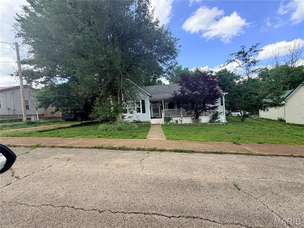 A great opportunity for investors! Cozy 2 bedroom, 1 bath home featuring a welcoming covered front porch. Home has large living room that opens to dining room/kitchen combo. Nice covered porch, cellar and also has detached garage/workshop.