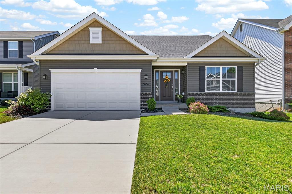 Looking for something new, but don’t want to wait to build? Or don’t want to spend the high costs to build now? This home is literally like new, less than one year-old with over $100,000 in upgrades! To build now would cost over $30,000 more, and you couldn’t find a lot like this awesome one, going all the way into the wooded area, and backing into common area, where no one will build behind you! And you can enjoy that PRIVATE view on your amazing composite deck, which many new homes don’t offer! This desirable open floor plan (Maple Model for those in the know!) offers 1844 sq ft on the main level with a huge vaulted great room, kitchen and dining area! Gorgeous upgraded carpeting, and gas fireplace in the great room. Stunning kitchen with upgraded cabinets, gorgeous quartz countertops, beautiful subway tile backsplash, fabulously huge island with bar seating on two sides, pantry and black stainless appliances, including refrigerator! Luxury vinyl tile flooring through kitchen and dining, as well as all baths & main floor laundry! Walk out the dining area to the beautiful composite deck and enjoy your coffee or a glass of wine in privacy with all the trees! Split bedroom plan with spacious primary bedroom with huge walk-in closet and full bath with walk in oversize shower! Two additional bedrooms and full bath, plus main floor laundry w/cabinets that includes the washer and dryer! The walkout lower level offers so much space for future finish with tons of space for an additional bedroom, recreation area, and rough in for a bath and still tons of storage. You'll love the expanded patio with a portion covered under the deck, as well as an even larger uncovered area! Neighborhood walk trails and convenient location to shopping and more!
