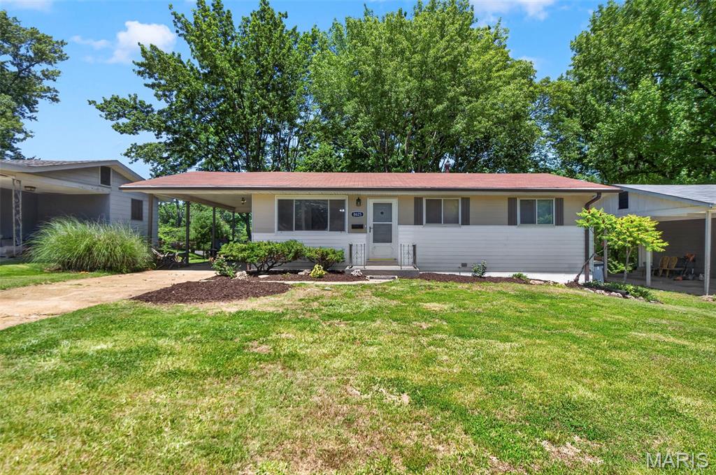 A beautiful ranch home featuring 3 bedrooms and 1.5 baths, ideally situated on a quiet street with no through traffic. This move-in-ready home feels like new, with professionally restored hardwood floors that showcase their natural beauty throughout the main living areas.

The updated kitchen offers new stainless steel appliances, including a cooktop, built-in oven, and dishwasher, along with new granite countertops, a new sink, and a modern faucet. New luxury vinyl plank flooring has been installed in the kitchen and bathrooms, while all-new LED lighting fixtures and fresh, on-trend paint create a bright and welcoming atmosphere throughout the home.

The finished lower level is a fun throwback to a bygone era, offering the perfect space for entertaining, game nights, and casual gatherings with family and friends.

A convenient one-car carport provides covered parking and offers the potential to be easily enclosed, creating a full garage for additional storage and functionality.

Outside, you'll find freshly landscaped grounds and an extra-large backyard shaded by mature trees, creating a private setting ideal for relaxation, entertaining, or outdoor activities.