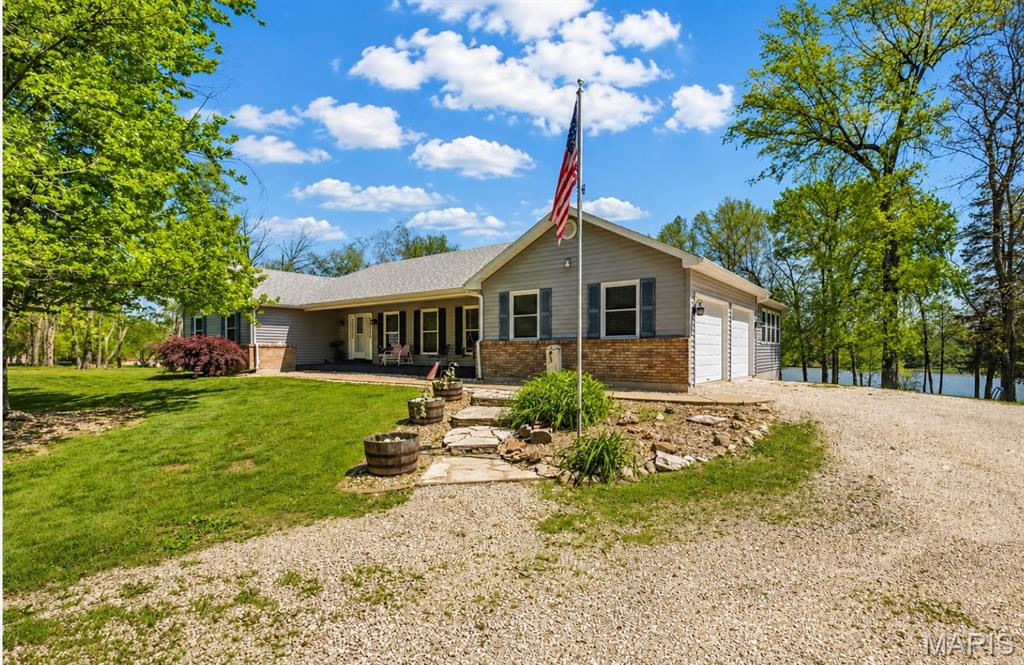 Back on the Market at No Fault of Sellers!!!  New Septic tank and Sump Pump Installed.
Lakefront living on 4.3 +/-; acres overlooking a picturesque 15-acre stocked lake! This spacious home offers just under 3,000 sq ft of main floor living, where vaulted ceilings in the family room, kitchen, dining, and primary suite create an open, airy feel filled with natural light. The eat-in kitchen is designed for gathering, featuring a large 4x8 island with overhang, abundant cabinetry, and a generous pantry. The dining area is highlighted by a bay window that frames peaceful lake views, while a see-through fireplace adds warmth and charm between the living room and dining space.
The primary suite is truly a retreat—generously sized with new paint and flooring, a bay window, private access to the deck, and its own see-through fireplace. The ensuite bath includes double sinks, a walk-in shower, water closet, and two walk-in closets. A sunroom wrapped in windows offers a quiet place to relax and take in the water views year-round.
The main floor also includes laundry with a full bath, a butler’s pantry with an updated half bath, and three additional oversized bedrooms (two with vaulted ceilings; fourth currently used as an office), providing flexibility for guests, work, or hobbies.
The walkout lower level is ready for your vision, already featuring a full bath, second rough-in, and framing for an additional bedroom—ideal for creating extra living space, a private suite, or recreation area.
Step outside to the 14x36 deck, perfect for morning coffee or evening unwinding, all set against a scenic lake backdrop. Additional features include an insulated 2-car garage, new roof and skylight, replacement windows and exterior doors, two heat pumps, humidifier system, 400-amp service, and newer hot water heater.
A rare opportunity to enjoy space, privacy, and lakefront living—just minutes from town and located in an area seeing significant growth and infrastructure investment, adding long-term value and appeal. Come experience the setting for yourself.