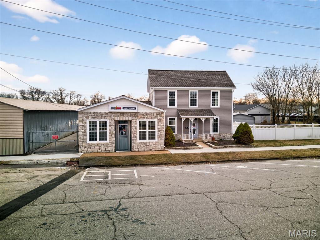 Amazing Building & Business location in downtown Pacific.   2-story building with plenty of space for offices, conference room, show room & kitchen area.  Large Drive-in Storage/Workshop area.  The property is security fenced with rear gate access and street front parking.   Additional outbuildings on property.  Estimated at 4,534sf on almost 1/2  acre- this is a Must See property.  Perfect location for most any business.  Professional Quality and craftsmanship.  Covered garage parking for 5+ vehicles and on-site storage for materials.   Main level consists of professional showroom space, kitchen area, lavatories, utility room, conference room and attached parking or storage.  Upper level is a carpeted area current used as offices.  The rear of the property has a small water feature, garden area, storage building and gated/secured parking area.