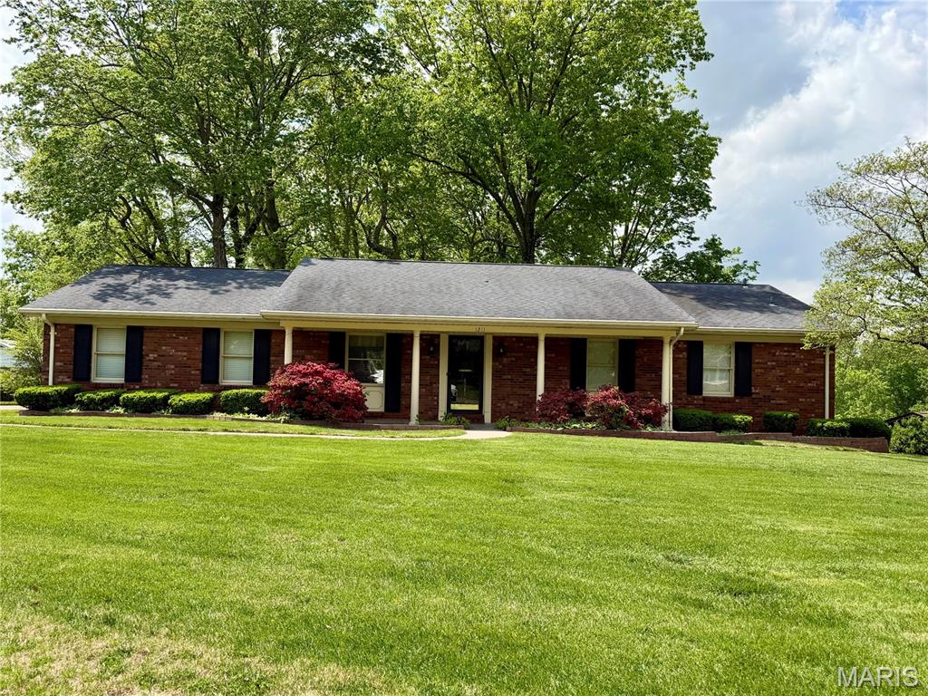 Charming brick ranch with curb appeal! Situated on a corner lot, this home features hardwood flooring in the main level living areas, two cozy fireplaces on both the main and lower levels, and a functional layout designed for comfortable living. The main floor offers three bedrooms, convenient main level laundry, and a separate dining area perfect for gatherings. The walk out basement expands the living space featuring a family room with built in bar for entertaining, an additional bedroom and bathroom and ample extra storage.
