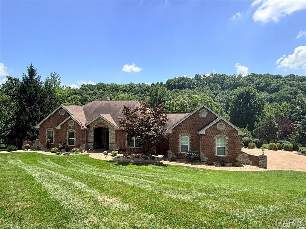 Welcome to luxury living in the heart of Missouri wine country! Nestled on a beautifully landscaped 1.12-acre lakefront lot in sought-after Augusta Shores, this stunning 4-bedroom, 3.5-bath atrium ranch offers nearly 4,800 square feet of thoughtfully designed living space and an incredible resort-style backyard. Step inside to an open, light-filled floor plan featuring soaring 12-foot ceilings, a dramatic wall of windows overlooking the backyard oasis, a cozy wood-burning fireplace, and elegant architectural details—including tray ceilings, crown molding, and recessed lighting. The chef's kitchen is designed to impress with granite countertops, a center island, breakfast bar, tile backsplash, stainless steel appliances, double ovens, 42-inch custom cabinetry, and an adjoining breakfast room surrounded by a beautiful five-bay window. The private primary suite is a true retreat, complete with a shiplap ceiling, crown molding, two custom walk-in closets, a spa-inspired bath with soaking tub, separate shower, dual vanities, and private water closet. French doors lead directly to a secluded deck overlooking the picturesque backyard. The finished walkout lower level is perfect for entertaining or multi-generational living, featuring an expansive family and recreation room with a second fireplace, a full second kitchen and bar, breakfast area, fourth bedroom, walk-in closet, and full bath. Outside, your own private paradise awaits with an in-ground pool, cascading waterfall, putting green, stocked lake, and expansive outdoor living spaces designed for relaxation and entertaining.
Augusta Shores offers an unmatched lifestyle with three stocked lakes, community pool, clubhouse, tennis, pickleball and basketball, a pavilion, hiking trails, and 1GB fiber optic internet included in the HOA. Located directly across from the Katy Trail and Klondike Park and surrounded by the rolling vineyards and award-winning wineries of Augusta, this exceptional home combines luxury, recreation, and breathtaking natural beauty in one unforgettable setting.