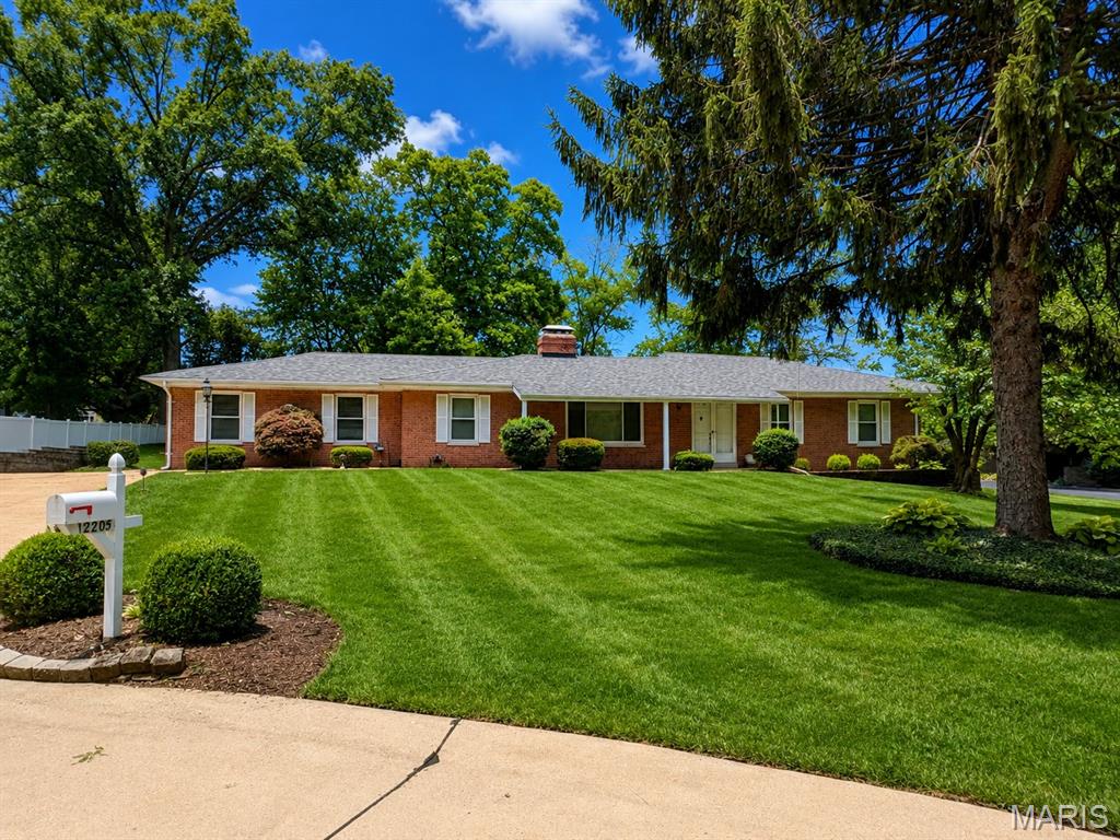 Classic Mid-Century Full-Brick Ranch located on a premium, well-manicured half-acre lot, nicely tucked away at the end of a quiet cul-de-sac.  Fabulous location close to all the amenities one desires!  Greeted by exceptional curb appeal and a welcoming front porch, enter to find 1,800 square feet of main floor living space, offering wonderful potential! Many improvements have already been made, including HVAC '22, roof, windows, 200-amp electrical service, and an irrigation system. With vision, creativity, and talent, this property could easily become your dream home. The foyer opens nicely into the spacious living room, featuring large windows and an attractive brick, double-sided gas fireplace as the focal point.  The adjoining dining room is the perfect place to gather with family and friends. Pretty tile flooring in both the kitchen and family room.  The kitchen, with a breakfast bar, opens nicely to the family room, which features a brick gas fireplace and a large bay window offering wonderful views of the lush, beautifully landscaped yard. From the kitchen, step out to a private covered patio for outdoor enjoyment. All three main floor bedrooms have wood flooring.  The primary bedroom features a private bath, while bedrooms 2 & 3 are serviced by the lovely hall bath. Great potential to add living space in the unfinished lower level, offering ample storage space and a half bath.  The attached 2-car garage completes this wonderful home.