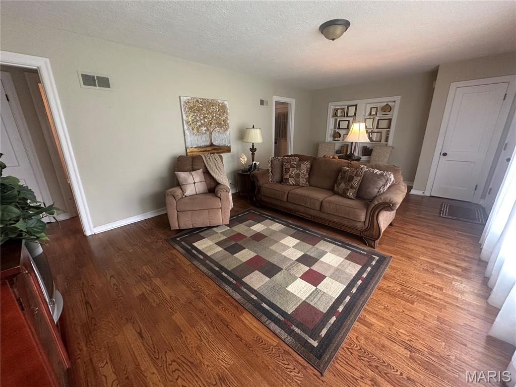 Move in ready.  1.5 story home with updated kitchen, bath, windows and covered deck.  Beautiful wood floors.  Main level plumbed for W & D.  Full walk up basement with 2nd bath & family room.  3rd bedroom dormer style.
