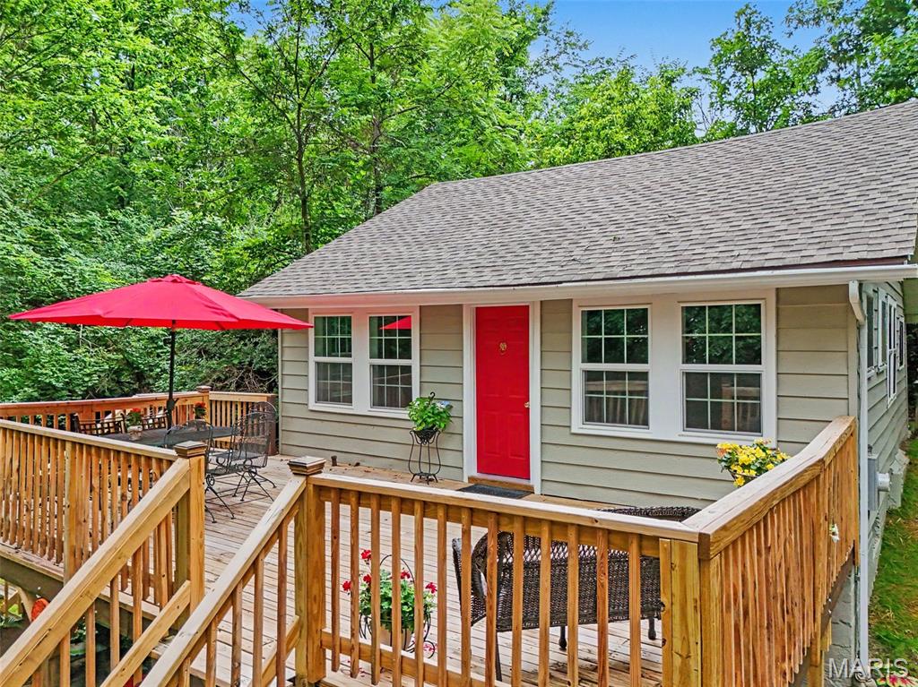 Tucked away in its own little sanctuary you will find this cottage in the woods! However, it's super close to conveniences such as banking, dining, grocery stores, hair salons and doctors. This home is ideal for a young couple starting out!  This renovated 2 bedroom 1 bath home has had many updates including roof, siding, windows, electrical, plumbing and HVAC.  Updates include fresh paint, new kitchen, new luxury vinyl plank flooring and so much more. Enjoy the LARGE (23x14) deck space while entertaining or enclose some of the deck and leave some to add additional living space. Don't miss the charm of the stained glass windows or the slider door leading to the upstairs flex space that can be a bedroom / play room or office. There is a separate dining room, a private back patio and plenty of room to add a pole barn if desired. This is one you won't want to miss.