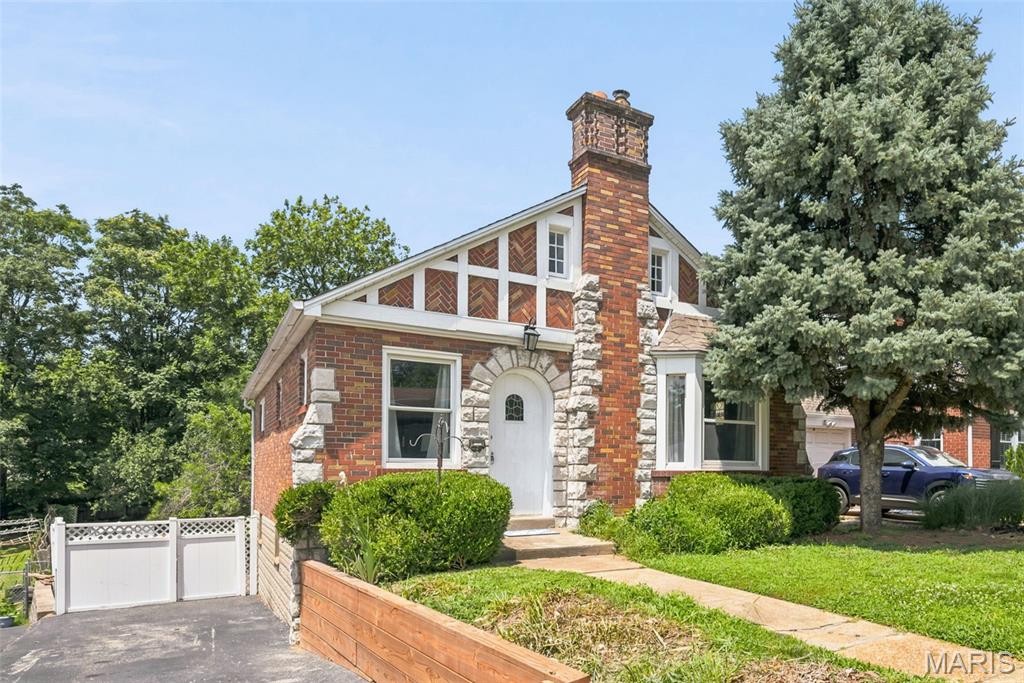 Not every home has a story to tell. This one does. 

When storybook charm meets modern urban farm lifestyle, you must pause and take notice. One of the most extraordinary lots you'll find in Brentwood can be yours in this timeless 3-bedroom, 2-bath home. It captures your attention from the moment you arrive with its striking Tudor-inspired architecture, arched front entry, brick and stone exterior, and undeniable curb appeal. Inside, you'll discover a home rich in character with original hardwood floors, beautiful stained-glass windows, classic arched doorways, and a stunning decorative stone fireplace aesthetic that serves as the centerpiece of the living room. The spacious dining room is perfect for entertaining, while the refreshed kitchen offers updated shaker style cabinets, new countertops, sink, faucet and stainless appliances. You’ll appreciate a thoughtful blend of modern convenience and vintage charm. A new water heater (2026) provides additional peace of mind. Main floor bedroom and full bath completes the first floor.

Upstairs delivers 2 bedrooms with a spacious primary retreat. Finished walk-out lower level adds valuable living space for a family room, home office, or recreation area and 2nd full bathroom. 

Step outside and prepare to fall in love. The backyard stretches more than 200 feet deep, creating a private oasis rarely found in this area. Whether you're dreaming of fresh vegetables, flowers, backyard gatherings, or a hobby farm, you'll appreciate the 6 established raised garden beds, 2 storage sheds, and charming custom built cedar chicken coop ready for your own flock. This is more than a house—it's a lifestyle full of warmth, personality, and endless possibilities. All of this may be yours in the heart of Brentwood. **OPEN SUNDAY 11AM - 1PM**