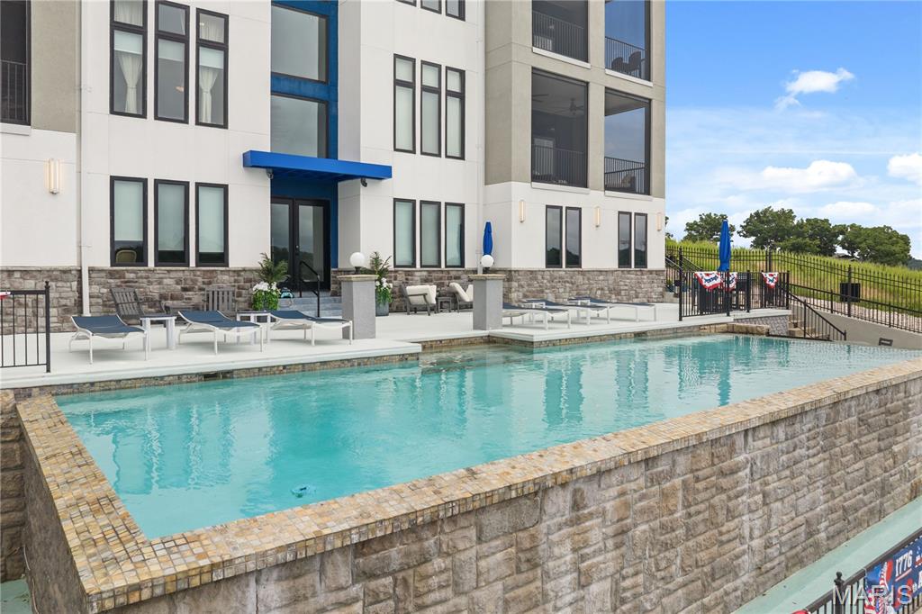 Welcome to the Exclusive Shores of Shawnee Bend, the Epitome of Luxury Living at Lake of the Ozarks! Nestled in this private oasis complex are only 6 units. Rentals are not allowed ensuring that each moment spent here is exclusively yours - free from crowds or disruptions. Available now is this Breathtaking First Class 3-bedroom, 3.5-bath condo on MM18 in Sunrise Beach boasting extraordinary craftsmanship and meticulous attention to detail showing off elegance and sophistication. Key Features include Gourmet Kitchen (Gas cooktop, Z Line appliances, XL Island, Honed Granite, Pantry), Open Floorplan, All Bedrooms are Large En-Suites w/Grand Bathrooms, High Ceilings, Turnkey, Garage, 12x32 Boat Slip with 7,500lb, PWC Slip, Huge Tiled Covered Private Balcony overlooking the Sparkling Pool & Captivating Main Channel Views, Gated Community, Elevator (no steps!), 9 minutes from Lake Ozark and SO MUCH MORE!!!! Tailored amenities include an infinity swimming pool, hot tub, public fire pit, & outdoor master grill. Come See This Beauty TODAY & Make this Your Piece of Paradise! Check out the Virtual Tour!