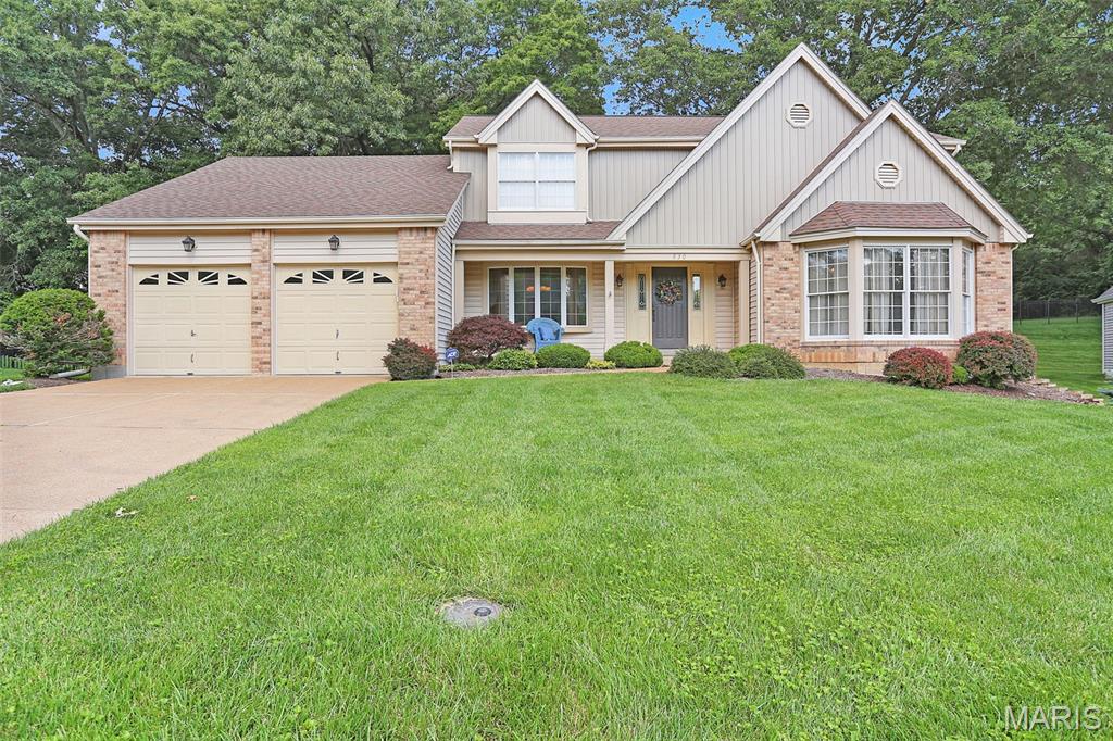 Welcome home to this beautifully maintained 1.5-story home in a prime West County location! Offering 4 bedrooms, 3 bathrooms, and an inviting open floor plan, this is a great opportunity to add value with some cosmetic updating.  
Step inside to a stunning vaulted great room featuring a  wall of windows that fills the home with natural light. The well-appointed kitchen is designed for both everyday living and entertaining, boasting a center island, stainless steel appliances, pantry, and breakfast room with direct access to the deck and private backyard.  The main-floor primary suite with a spacious walk-in closet and an ensuite bath featuring a soaker tub, dual vanity, and separate shower. Upstairs, you'll find three additional generously sized bedrooms and a full bath, offering plenty of space for family and guests.  Additional main-level amenities include a separate dining room, convenient main-floor laundry, bar area, and an attached 2-car garage. The full basement offers endless possibilities and could be finished to create additional living, recreation, or entertaining space.   Situated in a desirable neighborhood with excellent schools and easy access to major highways, this home is loaded with extras including crown molding, six-panel doors, an irrigation system, and more.  2 year old roof  Don't miss this exceptional opportunity to enjoy comfort, convenience, and space in one of West County's most sought-after locations!