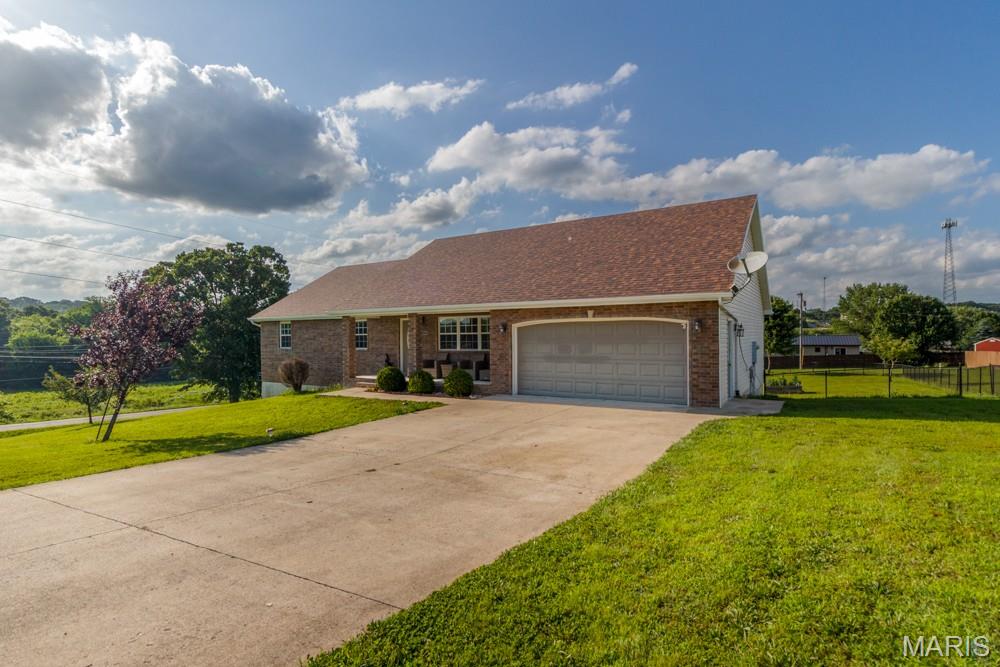 20485 Stagecoach Road in Waynesville is the kind of home that gives everyone room to feel at home. Located just minutes from the West gate of Fort Leonard Wood Missouri. Sitting on just over an acre, this spacious ranch offers 6 bedrooms, 3 bathrooms, and 3,636 sq ft designed for everyday comfort and easy gathering. The main level features warm living spaces, an open dining/living flow, stone counters, pantry, and a private primary suite with soaking tub, separate shower, double vanity, and walk-in closet. Downstairs, the finished walkout lower level is ready for movie nights, guests, hobbies, workouts, or multi-generational living with a family room, gas fireplace, gym, additional bedrooms, and full bath. Outside, enjoy the fenced yard, deck, patio, negotiable above-ground pool, and 2-car garage near Waynesville amenities. Buyer to verify all information.
