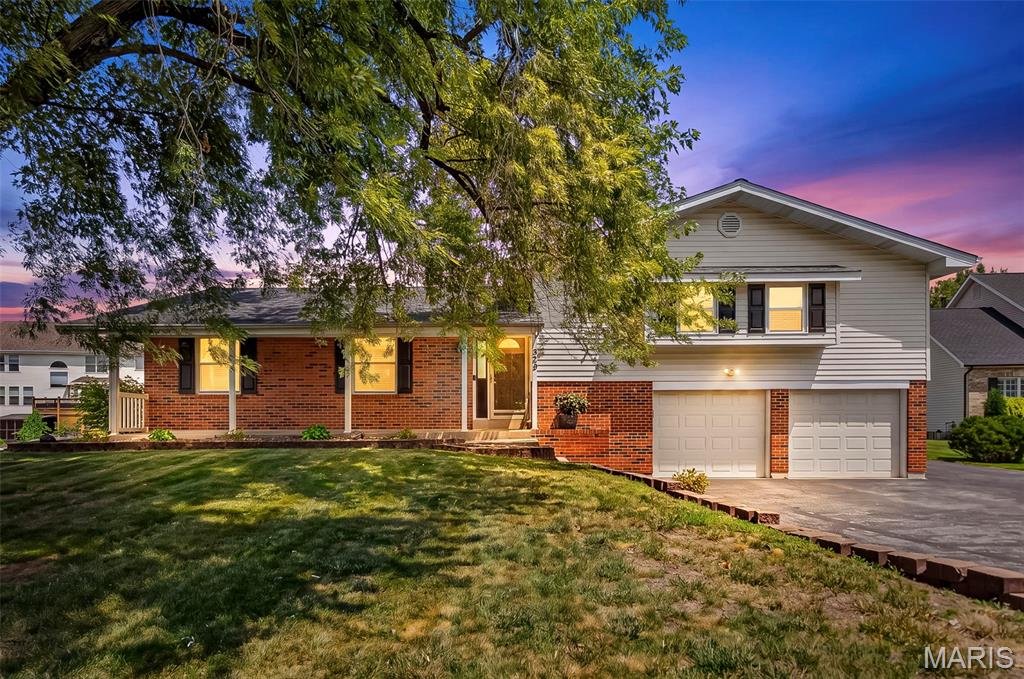 Here is your opportunity to own this lovely multi-level home in the very desirable Estates @ Legacy Pointe Subdivision in O'Fallon. 2000 sq ft of living space with a 2-car oversized garage on nearly a 1/3-acre lot. Very well maintained home with lots of updates. This home offers a large living room; the kitchen provides newer stainless appliances, granite tops, tile backsplash, a breakfast bar and a large pantry, it is open to the oversized breakfast room with a wood burning fireplace and a sliding door to the large concrete patio and fenced level backyard. Up just 6 steps and off the large hallway are 3 beds and 2 full baths. Laundry room and separate mud room with lots of storage to drop your coats and backpacks as you come in through the large, attached garage (25x20). More living area in the finished lower level with a bonus room (workout, family or playroom), bathroom and sleeping room. A long driveway and an asphalt pad on the side of the garage provides parking for an additional vehicle. Updated lighting, new bath vanities and freshly painted - updated and ready for you to move in and enjoy! Professional photos will be uploaded on 7-28-26. Agent is related to sellers