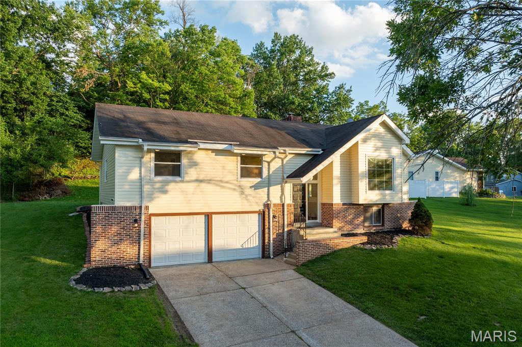Welcome to this exceptionally fully renovated home, offering a thoughtful layout and an abundance of functional space.
The main level features a living room highlighted by vaulted ceilings, oversized skylights that fills the space with natural light, and a classic fireplace, creating an inviting centerpiece for the home. The main living area flows seamlessly into the dining space and a completely updated kitchen, providing an ideal layout for both daily living and entertaining. Sliding doors open from the main living space to a spacious outdoor deck, perfect for outdoor dining and relaxation. The private residential wing includes a spacious primary bedroom suite with a dedicated full bath, along with two additional bedrooms and an updated hall bathroom. The lower level features a partially finished basement complete with a bar, creating the perfect space for a home theater or additional living area. This level also includes an oversized two-car garage with tons of storage space, and a laundry/utility space. 
With every modern update already taken care of, this cozy and inviting property is just waiting to welcome you home.