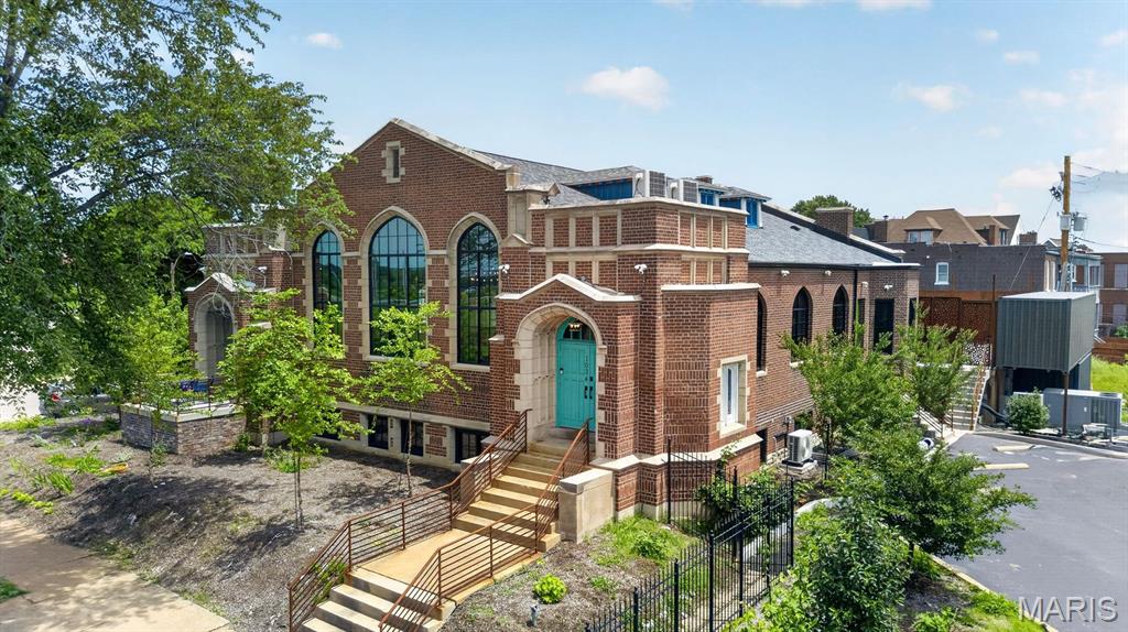 Rising prominently along South Kingshighway Boulevard, just moments from Forest Park, Central West End, and the Grove, this extraordinary early-1900s church has undergone a remarkable transformation into one of St. Louis’ most distinctive and inspiring properties.  Once abandoned and forgotten, the building has been meticulously restored and reimagined by internationally recognized artist Nabil Mousa, creating a rare fusion of historic architecture, contemporary design, and limitless possibility. Rich in character and impossible to duplicate, the property offers an experience unlike anything else currently available on the market.
At its heart is a breathtaking sanctuary crowned by soaring 25-foot ceilings, dramatic arched windows, preserved architectural details, and vibrant designer chandeliers. The expansive space evokes both grandeur and intimacy, providing an unforgettable setting for living, entertaining, creating, gathering, or showcasing a collection.
Throughout the property, historic craftsmanship has been preserved while bold modern interventions create a dialogue between past and present. Custom iron and glass elements, hardwood flooring, refined finishes, dramatic lighting, and thoughtfully curated spaces transform the building into a true architectural statement.
The residence includes a gourmet kitchen anchored by a stunning 20-foot island, multiple living areas, lounges, a library, loft spaces, and private guest retreats. 
Below, approximately 7,000 square feet of additional space offers exceptional flexibility for galleries, studios, offices, wellness facilities, creative enterprises, hospitality concepts, private collections, or future expansion.
Outside, nearly 3,000 square feet of secluded courtyard space extends the experience beyond the walls of the building. Enclosed by a custom 9-foot ornamental iron fence, the grounds are being completed with elevated decking, lounge areas, spa accommodations, and two shipping-container structures that present endless possibilities for a future outdoor kitchen, bar, guest suite, studio, or creative workspace.
Significant infrastructure improvements—including a new roof, structural restoration, eight HVAC systems, three-phase electrical service, new windows, flooring, plumbing, and extensive stone restoration—provide the confidence of modern systems within a building of historic significance.
Whether envisioned as an extraordinary private residence, iconic live-work environment, creative campus, wellness retreat, boutique hospitality concept, event destination, medical or professional headquarters, or investment opportunity, this property offers something increasingly rare: a place with soul, history, and the ability to become whatever its next steward dares to imagine.
This is more than real estate. It is a landmark. A conversation piece. A living work of art.
And perhaps the most extraordinary adaptive reuse opportunity available in St. Louis today.