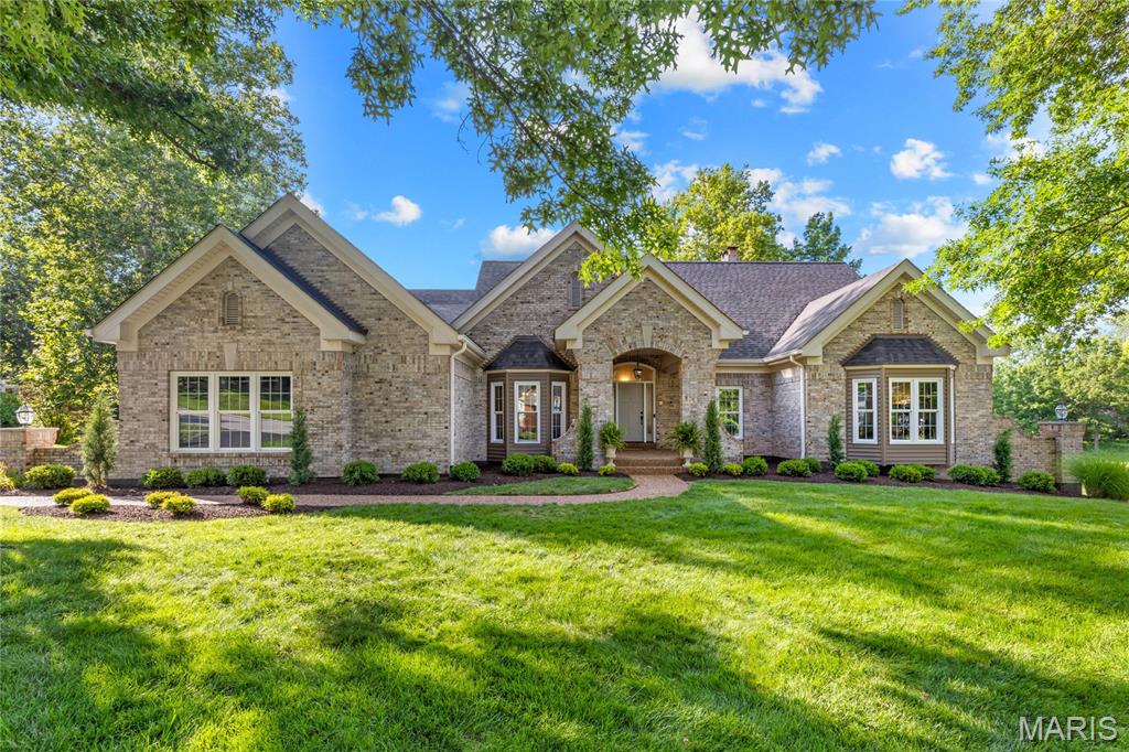 This stunning great-room ranch by award-winning Hardesty Homes offers spacious living, elegant design, and breathtaking views of the lake and the 14th and 15th fairways of the North Course. A dramatic covered porch framed by wing walls welcomes you into an impressive marble foyer. The main level features a private study, formal dining room with an octagonal ceiling and bay window, and a spectacular great room highlighted by a floor-to-ceiling stone fireplace, built-in bookcases, quartz wet bar, and sliding glass doors leading to the deck. The recently remodeled chef’s kitchen showcases 42-inch white shaker cabinetry, quartz countertops, stainless steel appliances, a 7-foot center island, and a butler’s pantry. Adjacent to the kitchen, the vaulted breakfast room is surrounded by walls of windows that capture the home's beautiful setting. The luxurious primary suite serves as a private retreat, featuring a cathedral ceiling, two customized walk-in closets, and a spa-inspired bath with a jetted tub. Two additional bedrooms connected by a Jack-and-Jill bath complete the main level. An open staircase leads to the walk-out lower level, thoughtfully designed for entertaining and relaxation featuring a 9' foundation pour. Highlights include a recreation room with a brick fireplace and wet bar, a game room, private office, and two guest suites. Situated on a premium lot, outdoor living spaces include a composite deck, covered patio, and an expanded three-car garage with golf cart storage. Residents enjoy an exceptional golf-course lifestyle with access to a clubhouse, swimming pool, tennis courts, fitness center, and a 36-hole championship golf course.