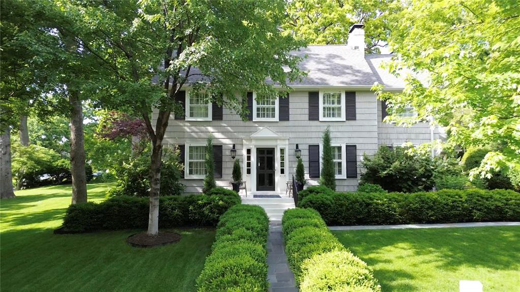Nestled in the highly sought-after Sherwood Forest neighborhood, this timeless home blends traditional charm with modern comfort—perfect for a forever residence. Step inside to a spacious living room featuring a classic fireplace and elegant French doors that open to a sunlit den or private office. At the heart of the home lies an entertainer’s dream kitchen, complete with a butler’s pantry, wine fridge, and seamless flow into a paneled dining room and cozy family room. A grand sliding door leads to your private outdoor retreat—featuring a bluestone patio, built-in gas grill, bar seating, and a stunning outdoor fireplace. Upstairs, the primary suite offers a walk-in closet and an attached office or nursery. A second ensuite bedroom, plus two additional bedrooms and a shared bath, provide ample space for guests. Dedicated mudroom and a versatile rec room round out the home’s practical layout. Classic design, thoughtful upgrades and a prime location, this home checks every box.