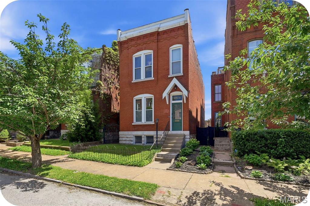 Comfort, convenience, and character come together in this beautifully updated 2-story home in the highly walkable Benton Park neighborhood. The main level offers an ideal blend of historic charm and modern updates, featuring a welcoming living room with a gorgeous decorative fireplace and built-in shelving. The spacious family room showcases exposed brick walls, hardwood floors, tall ceilings, and an open layout that flows seamlessly into the updated eat-in kitchen. You'll love the center island, granite countertops, tiled backsplash, stainless steel appliances, pantry, and ample space for gathering and entertaining. A convenient half bath completes the main floor. Upstairs, the primary suite features its own full bath and private balcony. A second generously sized bedroom offers another decorative fireplace and abundant closet space. An additional full bath, second-floor laundry, and a versatile open flex space provide endless possibilities for a home office, reading nook, playroom, or additional living area.
The lower level offers plenty of storage along with a bonus workshop space. Outside, enjoy a spacious deck, concrete patio with built-in fire pit, low-maintenance fenced yard, and a two-car garageport. Located just steps from Benton Park and surrounded by popular restaurants, breweries, coffee shops, and nightlife, this home offers the best of city living. With easy highway access, commuting and exploring everything St. Louis has to offer couldn't be more convenient.