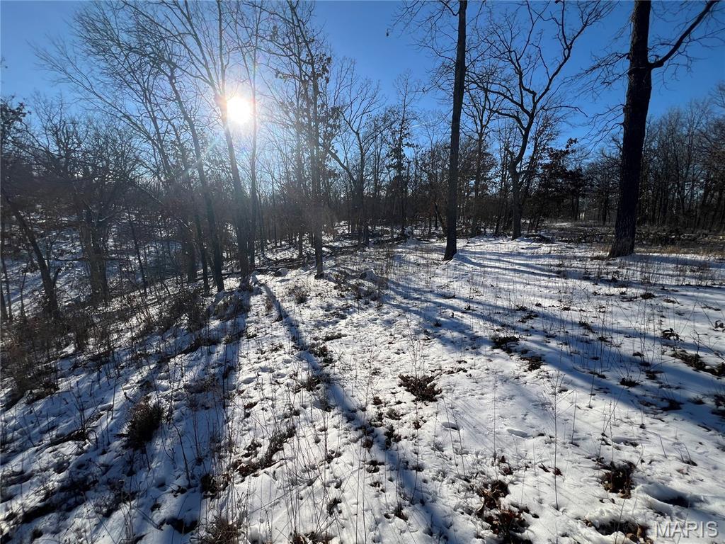 This attractive property (with no HOAs, covenants or deed restrictions) offers excellent access via a well-maintained county road. It features scenic wooded areas and is conveniently situated between Lake of the  Ozarks and Truman Lake, with quick highway access. Ideal for a peaceful weekend retreat, a place to hunt, a spring board to a day on the water, or as a serene location to build your dream home.