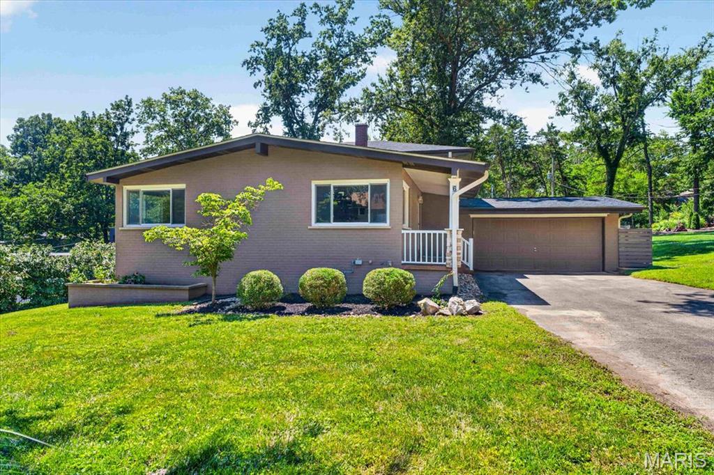 Tucked away on a quiet cul-de-sac in the highly sought-after Ladue School District, this beautifully updated 4 bedroom, 2 bath home offers the perfect blend of comfort, style, and space. This multi-level mid-century home is located on a beautifully landscaped, park-like lot of more than half an acre which provides peaceful setting while remaining conveniently close to shopping, dining, and major highways.
The heart of the home is the open floor plan kitchen featuring granite countertops, custom cabinetry, stainless steel appliances including brand new stove, and an oversized island with plenty of seating —perfect for everyday living and entertaining. Hardwood flooring on main and upper level and engineered hardwood flooring on lower level creates a warm inviting atmosphere. Freshly painted throughout! 
The walk-out family room offers additional living space complete with a charming decorative fireplace and easy access to step outside to the expansive patio, surrounded the backyard, lined with mature trees and plenty of room to relax, play, or host gatherings.
Additional highlights include an attached two-car garage with an epoxy-coated floor, updated windows throughout,5 year old HVAC and 5 year old roof, providing peace of mind for years to come.  This move-in ready home combines timeless updates, generous living spaces, and an exceptional location in one of St. Louis' most desirable school districts.
