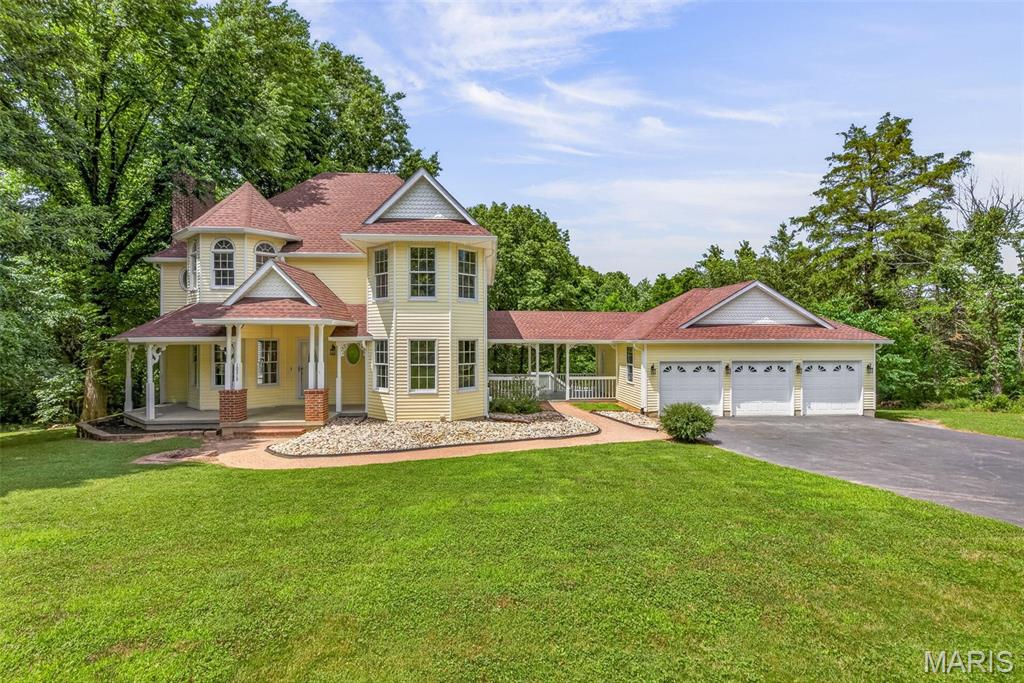 STUNNING LANDSCAPE!  Sip coffee from the front porch while admiring the beautiful blooming magnolia tree and the sprawling lawn.  Outdoor entertaining has never been easier so enjoy dining alfresco style on the covered side porch while overlooking the sparkling water of inground pool.  Entering the private residence you get a sense of luxury as well as creativity in the design features of this custom built 2-story home.  Great room boasts gleaming hardwoods floors, woodburning fireplace and lots of windows.  Sunroom is sure to be one of your favorite places in the home to curl up and read a good book.  Formal dining room and breakfast room both have wonderful flow to the kitchen.  Upstairs boasts a one-of-a-kind primary bedroom/bath suite complete with turret-ceiling design, accent window and jetted soaking tub.  Other bedrooms are generous in size and have lots of closet space to help stay organized.  Finished walkout basement has large recreational room with built-in accent shelving.  Various other spaces provide opportunities for a work-from-home space, sleeping room, sitting room, play room, home gym or creative space.  All this nestled in on 2 acres in the sough-tafter Ridgeview Acres neighborhood.  3 car, oversized garage.  While you enjoy the peace and quiet you can still appreciate that you are only minutes from the public park, shopping, schools and more.  This is your chance to own a piece of paradise.  CALL TODAY TO TAKE A LOOK INSIDE