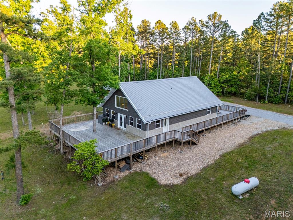 Discover a rare opportunity to own your own slice of paradise near the lovely Big Piney
River in the Houston, MO area. Featuring a charming 3-bedroom, 3-bath home on 10
private acres, this one-and-a-half-story home offers warm, inviting character throughout,
with natural wood finishes and an updated kitchen complete with stainless steel
appliances. Upstairs features a loft overlooking the family room, perfect for an office or a
hang out space, as well as a separate princess suite with an attached full bathroom,
perfect for visiting guests. Outside, a scenic pond provides a peaceful place to fish or
watch the deer and other visiting wildlife, and trails throughout make it easy to enjoy
every acre. Whether you’re looking for a full-time residence, or a weekend getaway to
unplug and get back to the simple enjoyments of life, this property delivers exceptional
versatility. Its proximity to the Big Piney River opens the door to floating, fishing, and
endless outdoor recreation. For those who would like more acreage, up to 61.92 acres
of additional acreage is available. Don’t miss out – call today for your private tour!