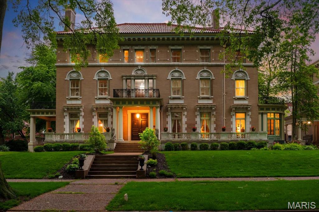 Step into a piece of history upon entering this stunning mansion on private and prestigious Washington Terrace, a street in the National Register of Historic Places and a St. Louis City Landmark. This 1903 Second Renaissance Revival masterpiece, designed by architects Weber & Groves, perfectly blends grand architectural heritage with refined modern amenities. Upon arrival, the stately portico columned entrance flanked by guardian lions sets a tone of timeless elegance, continued with a classic porte-cochere over the side door entrance—a rare architectural touch that provides both style and sheltered convenience. Spanning an impressive 9,667 square feet, this 18-room historic landmark offers an expansive floor plan designed for both grand-scale entertaining and sophisticated everyday living. The elegant foyer leaves you in awe as your eyes take in the beauty of glistening refinished hardwood floors and old-world early 20th century ornate craftsmanship. Exquisite Arabesque carvings in a rich, dark finish adorn the wood throughout the entryway and staircase. The home’s heritage is preserved through 10 sets of pocket doors and 9 hand carved fireplace mantels distributed across all three levels. On the main level you’ll find a parlor with hand carved cherub embellishments on the massive mantel, intricate ornate crown molding and floor to ceiling windows, a library with original built-in desk/bookcases and an ornate ceiling border, a living room with exquisite crown molding and the original non-electric candle chandelier, a curved solarium with access to the private courtyard, a formal dining room with a sparkling Waterford crystal chandelier as its focal point, and a Chef’s Masterpiece Gourmet kitchen - a stunning blend of historic charm and modern conveniences. Featuring a hearth room, brick walls, tall arched windows, and granite countertops, it is fully equipped with premium appliances: a Gaggenau cooktop, Subzero refrigeration, Electrolux double ovens, and a Bosch dishwasher. A separate coffee/wet bar with a beverage refrigerator and a dedicated breakfast seating area complete the kitchen. The beautiful Grand Staircase includes a curved window seat with leaded glass soaring to the ceiling and leads you to the 2nd floor Grand Landing highlighted by 2 stunning crystal chandeliers. From there, step out onto the front balcony and enjoy the view of this historic street. The Primary Suite includes a Powder/Dressing Room with 2 walk-in closets, as well as an ensuite bath with built-in closets and access to the side balcony. Also on the 2nd floor, you'll find 3 more bedrooms, and 2 original marble bathrooms. The 3rd floor boasts an additional 3 bedrooms, a full bath, and a craft/hobby room, as well as a media room and a ballroom/recreation room, both ideal for grand entertaining. A 4th level of space - the attic - accessible from the media room, has 15-foot ceilings and has been used as a roller-skating rink in the past with a disco ball at its center. For relaxation, the home offers 4 private balconies—including one overlooking the pool—and two featuring newly installed copper flooring. All of this space, plus central air-conditioning (3 new condensers installed in 2025) and radiant heat throughout the home, offer ample space for family and guests to retreat in comfort. Outside, the grandeur continues with a 3-car garage equipped with EV chargers, an in-ground, heated, saltwater pool, a wraparound porch with hot tub and a beautiful English garden/courtyard adjacent to the curved solarium – areas all perfect for entertaining. A home of this scale and pedigree is a rare find. Over $1 million has been put into the home since the current owner purchased it in June of 2021, with most of the improvements being done in the past 2 years.  Don’t miss your chance to own this Grand, Magnificent Masterpiece!