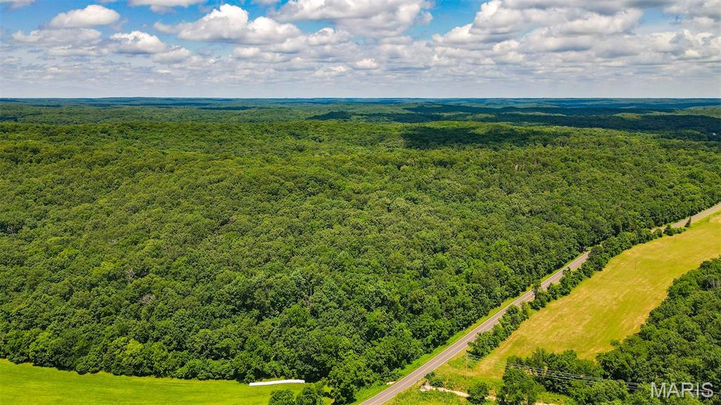 Here is your chance to own 46.53 surveyed acres in the Gravois Mills / Versailles area, near Lake of the Ozarks. Properties like this are hard to find right now— offering the perfect blend of recreation, convenience, and proven hunting success. This diverse tract truly has a little bit of everything. The landscape features South and North facing ridges, valleys, mature timber, thickets, established food plot locations, low ground, wet-weather creeks, and a well-maintained trail system that makes navigating the property easy by foot or ATV. The habitat diversity creates ideal travel corridors and bedding areas for wildlife, making this property extremely productive for both deer and turkey hunting. In fact, this is one of those rare places where you can step out of the truck and realistically have a chance to harvest an animal the very same day. The area is well known for producing trophy-caliber whitetails, and the mix of timber and openings also provides excellent opportunities for spring turkey hunting. Beyond hunting, the property offers great recreational value for mushroom hunting, artifact searching, hiking, or simply enjoying the outdoors. Plus, you’re only minutes from Lake of the Ozarks public launch for fishing or boating at any time. 
Adding to the appeal is a fully finished container cabin designed for comfortable stays during weekend getaways or extended hunting trips. The cabin is supported by generator power, and includes air conditioning, propane heat, and a self-contained water holding system. Inside, you’ll find a thoughtfully laid-out space with a living area, kitchenette, bedroom, and bathroom, providing everything needed for a cozy and functional base-camp. Conveniently located with hardtop road frontage, this property offers easy access while still maintaining the privacy and seclusion that outdoor enthusiasts desire.
Whether you're looking for a turn-key hunting retreat, acreage to build on, a recreational getaway, or a unique property in the Lake of the Ozarks region, this tract is truly one of a kind.
Schedule your showing today and come see what makes this property so special.