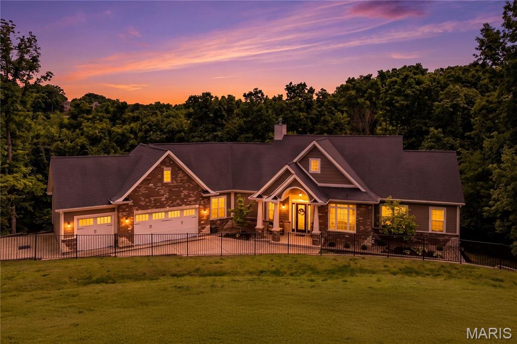 Privately set at the end of a cul-de-sac in Ballwin, this custom atrium ranch offers a hard-to-find combination of acreage, privacy, and location in the Rockwood School District. Surrounded by mature trees on 7+ wooded acres, the setting feels like a retreat, with peaceful views in every direction and the calming soundtrack of nature.

Inside, natural light steals the show. A dramatic wall of windows frames the landscape and brings the outdoors in, creating ever-changing views of spring blooms, summer green, fall color, and winter calm. Fresh paint and new flooring (April 2026) add a crisp, updated feel while the home’s craftsmanship and thoughtful layout deliver the space buyers want today.

Designed for both hosting and everyday living, the main level features open gathering areas, soaring ceiling lines, a fireplace, and a wet bar that makes entertaining effortless. The kitchen is built for serious cooking with high-end appliances, custom cabinetry, and quality finishes, and it connects seamlessly to a warm hearth room with a second fireplace. A true functional win: the laundry and mudroom with custom cubbies creates the perfect drop zone and leads directly to an oversized 3-car garage.

The primary suite is a private escape with its own balcony overlooking the acreage and a spa-inspired bath. Outdoor living is equally impressive with a newer two-tier rear deck, ideal for grilling, dining, or simply unwinding while watching wildlife and listening to the trees.

With 5 bedrooms, 3 full baths, and 2 half baths, plus over 4,900 square feet of total living area, the finished lower level provides exceptional flexibility for a media room, game space, guest accommodations, home office needs, fitness area, or multigenerational living. An added parking pad provides plenty of room for visitors, making get-togethers easy.

A rare West County opportunity that lives like a private estate yet remains close to parks, shopping, restaurants, and convenient highway access. If you’ve been searching for a custom home on acreage with views, privacy, and room to breathe, this is it.