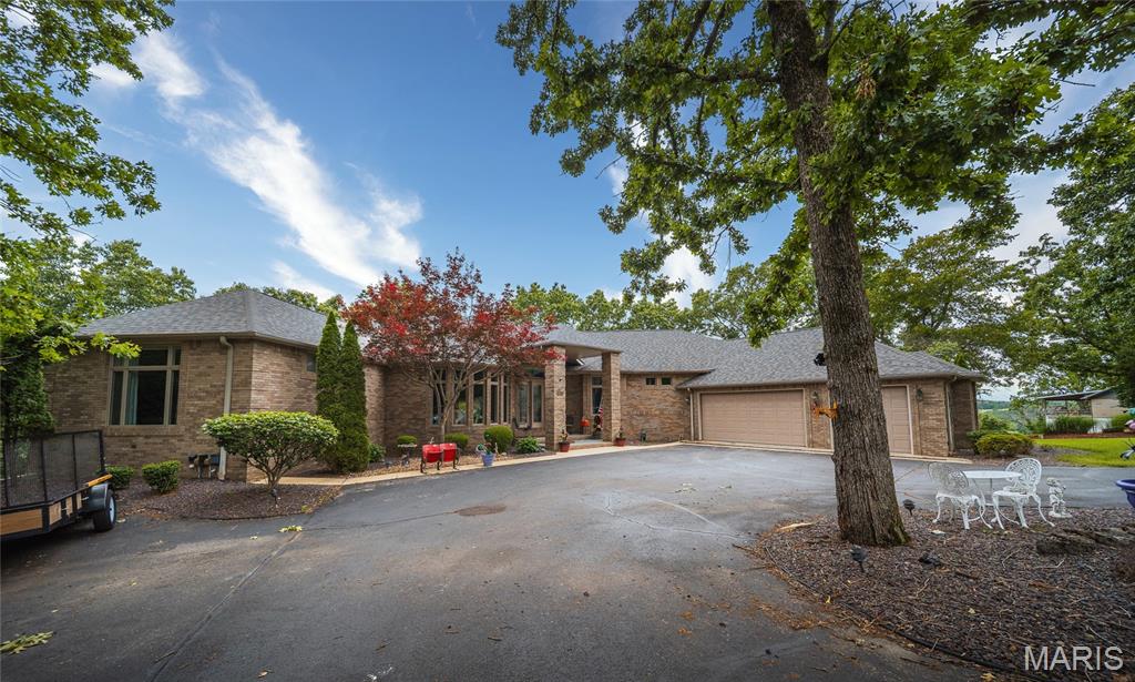 Take a look at this spectacular, all-brick ranch home featuring a one-of-a-kind Jack Nicklaus custom putting green! As you pull up the driveway, you are greeted by meticulous, beautiful landscaping and a grand entryway that highlights the home's unique architectural design.

The main level boasts an open floor plan and a grand master suite complete with a king-and-queen vanity, a separate soaking tub and shower, and spacious his-and-her walk-in closets. Move into the pristine kitchen, where you'll find custom cabinets thoughtfully equipped with pull-out drawers. Relax or watch local wildlife year-round from the comfort of the light-filled sunroom.

The fully finished, walk-out lower level includes two additional bedrooms, each featuring its own private deck access, full bathroom, and walk-in closet. With custom built-in shelving throughout, stunning views from every single room, expansive outdoor decking, and a central vacuum system, this impressive home truly has it all!