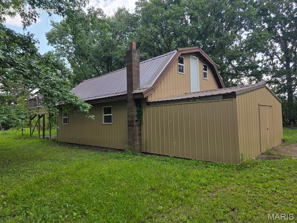 Residential lot with lots of possibilities! This 1.46 acre lot features a 30x26 shop building with concrete floors and electric and finished insulated loft. Large deck overlooking the property and additional parking below. Plenty of room to build, add a mobile or RV. Rural water and electric available on site. Within a short driving distance to Montauk State Park and other local amenities.