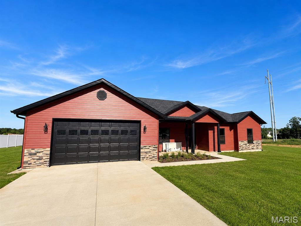 Four Bedroom Two Bath New construction home on approximately 0.40 acre m/l featuring a functional open layout and quality finishes throughout. The great room offers 9 ft ceilings and flows seamlessly into the large kitchen and dining area, creating a bright and inviting space. Kitchen includes stainless appliances along with a walk in corner pantry for added storage. living area provides access to the back patio through a sliding patio door.
Split bedroom design with a spacious primary suite offering a tray ceiling, walk-in closet, and private bath with custom tile walk-in shower.
Separate laundry room with tile flooring. Home is all electric with central heat and air.
Exterior features include barn red vinyl siding with rock accents, a sodded front yard, and seeded and straw backyard. Two-car attached garage design adds curb appeal and functionality.