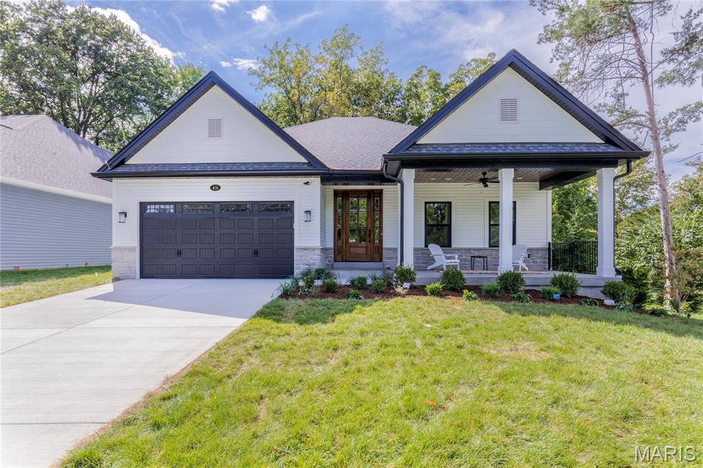 Pentrex Development hit the ball out of the park again... BLACKBURN PARK this time! This home has the best of both worlds, with an incredibly manageable yard, with its own private gate opening to 36 MORE ACRES of tennis and PICKLEBALL COURTS, ball fields, pavilions, playgrounds, walking paths, and a bird sanctuary! But the incredible craftsmanship of this BRAND NEW construction is the real MVP, with each detail more beautiful than the last. From the welcoming COVERED FRONT PORCH, with stained wood ceiling and ceiling fan, through the stately MAHOGANY entry door, you will find high ceilings, DELUXE moulding, and durable HARDWOOD throughout all the main areas. A full wall of trimmed-out black windows, with TRANSOMS above, provide a picturesque PARK VIEW, with a gazebo straight out of the movies. Whether cozying up to the fireplace on a snowy evening, or entertaining all of your favorite people at the 11' Kitchen ISLAND, it's the perfect backdrop. Wet bar with beverage center, gorgeous backsplashes, custom backlit cabinetry, walk-in pantry and an abundance of countertop space create the perfect environment for absolutely any moment. CARPET FREE LIVING extends to the Lower Level where a huge Rec Area, 2 additional bedrooms, an EXERCISE Room and a full bath finish the home. You will not want for anything when you choose this house as your next home. When should we look for you?