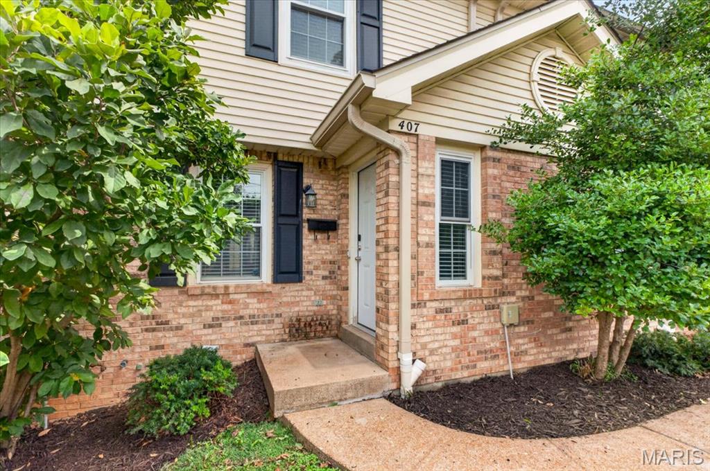 Welcome home to this beautifully updated townhome nestled in the heart of desirable Kirkwood! Offering 2 bedrooms, 2 full baths, 2 half baths, and over 1,650 square feet of finished living space, this move-in-ready home perfectly blends modern updates with everyday comfort. Step inside to discover gorgeous hardwood floors and a bright, open main level designed for both entertaining and daily living. The spacious living room flows seamlessly into the dining area and stunning, fully updated kitchen featuring sleek gray cabinetry, quartz countertops, stainless steel appliances, subway tile backsplash, a center island with seating, and contemporary lighting. Just off the dining area, enjoy easy access to the private patio, perfect for morning coffee, grilling, or relaxing outdoors. Upstairs, the spacious primary suite offers vaulted ceilings, a large walk-in closet, and an updated ensuite bath with dual vanities and stylish finishes. A generously sized second bedroom also features vaulted ceilings and its own private full bath, providing comfort and privacy for family or guests. The finished lower level expands your living space with a large family room, recessed lighting, a convenient half bath, and plenty of flexibility for a home office, media room, fitness space, or recreation area. The unfinished utility area provides additional storage and laundry space. Additional highlights include a one-car garage, beautifully maintained landscaping, and a low-maintenance lifestyle in the sought-after Van Buren Place community. Located just minutes from downtown Kirkwood, you'll enjoy award-winning schools, local boutiques, restaurants, parks, farmers markets, and easy access to major highways. This exceptional home offers the perfect combination of style, convenience, and location, don't miss your opportunity to make it yours!