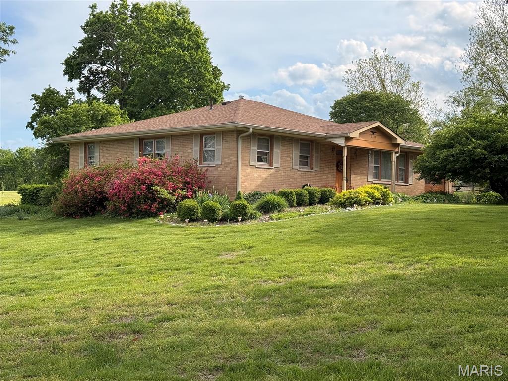 This PERFECT homesteader property, RIGHT OFF South HWY 94, features 1+/- level acres with 1,718+/- SqFt ranch FULL brick home, 2-car attached garage & 1-car detached garage! CHARMING 3 bedroom & 2 full bath home. Covered front porch greets you as you step inside. Mostly carpet flooring throughout. Living room boasts a wall of windows & French door entry to Dining room with a glass door walk-out to patio allowing plenty of natural light. Eat-in kitchen offers custom cabinetry, white appliances & Formica countertops. Primary suite with slide closet, & ensuite full bath with a shower & single sink vanity. Other 2 bedrooms with slide closets & share hall bath with a shower/tub & single sink vanity. Laundry room & sitting room complete the main level. Unfinished basement has great potential for additional living space just awaiting your finishing touches with 8’+/- ceilings & an abundant amount of storage space. Within the Francis Howell School District & easy access to HWY DD & HWY F. SCHEDULE YOUR SHOWING TODAY! :)