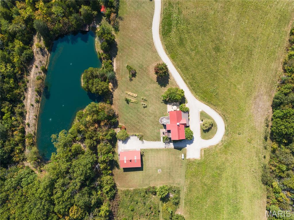 Absolutely gorgeous setting for this wonderful country home on 42 acres with a 1+ acre stocked lake, wonderful guest cabin/studio & 40x30 Morton Building barn. Less than 15 minutes to Hermann wineries & shops or on your bike at the Katy Trail in 10 minutes! Extraordinary custom timber frame home with beautiful views of woods, fields & lake. Original owner/architect designed; the home offers cozy rooms sitting by the 3 fireplaces (one on each floor). Updated kitchen boasts 2 pantries, one walk-in, quartz countertops & updated appliances. The primary bedroom offers a spacious walk-in closet & renovated bath. Enjoy a beautiful loft area (which could be 4th bedroom) & children's play room/library area. The open design offers plenty of light with large windows & sunny views. A finished lower level (included in total sq/ft) offers a bedroom & full bath, family room & plenty of storage. New HVAC 2022. Enjoy a cozy cabin by the lake, 2 docks, fishing and hiking! Duplicate listing of 25023431 Suitable for Bed/Brk