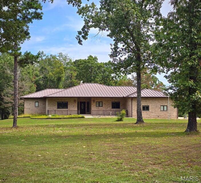 Spectacular country estate home on a peaceful setting in rural Texas County, Missouri. Welcome to 20404 Alpine Trail, a quiet retreat nestled in the Ozarks. This very well built custom 6,000 sq ft home sits on 19 acres of natural beauty and offer country charm, modern comfort, and craftmanship designed to stand the test of time. The main level offers a large central living room with woodburning brick fireplace, 15x26 primary bedroom with a custom 11x16 walk in closet, formal dining, den, and a gourmet kitchen sure to be the envy of all your friends. Downstairs offers a large living room, family room, 2 bedrooms, full bath, kitchenette, office space, shelved storage room, and so much more! An attached oversized 3 car garage with workspace for added convenience. Wrapped in brick and stone, metal roof and a new whole house Generac generator for peace of mind. Outside you will find a 3 stall loafing shed with attached tack room, workshop with electric, a lovely pond and open pasture ground perfect for a horse or two. Miles of horse riding trails for outdoor enjoyment right out your door. Enjoy soaking up the sounds of nature, peace and quiet whether you are looking for a hobby farm, permanent residence or weekend getaway. Located on a quiet country road, yet within easy reach of Houston, MO, 2 hours to St. Louis and near 1000's of acres of National and State Forest Land. If you are searching for a well constructed country home, 20404 Alpine Trail is ready to welcome you.