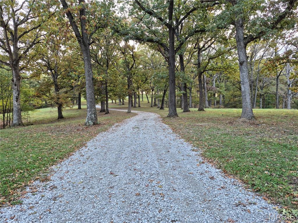 Discover the perfect blend of natural beauty and modern convenience on this exceptional 26+/- acre property featuring underground electric and water, mature trees, and stunning panoramic views—an ideal setting for a dream home or private retreat. Protective deed restrictions allow up to two homes of at least 1,200 square feet each while prohibiting mobile or modular homes, hog confinement buildings, junkyards, race tracks, or logging beyond what’s needed to clear a homesite, helping preserve the land’s beauty and value. Outdoor enthusiasts will appreciate the abundant wildlife, including turkey and trophy-class bucks, making this a rare opportunity to own a private, scenic, and well-maintained tract. Additional acreage available. Agent Owned.