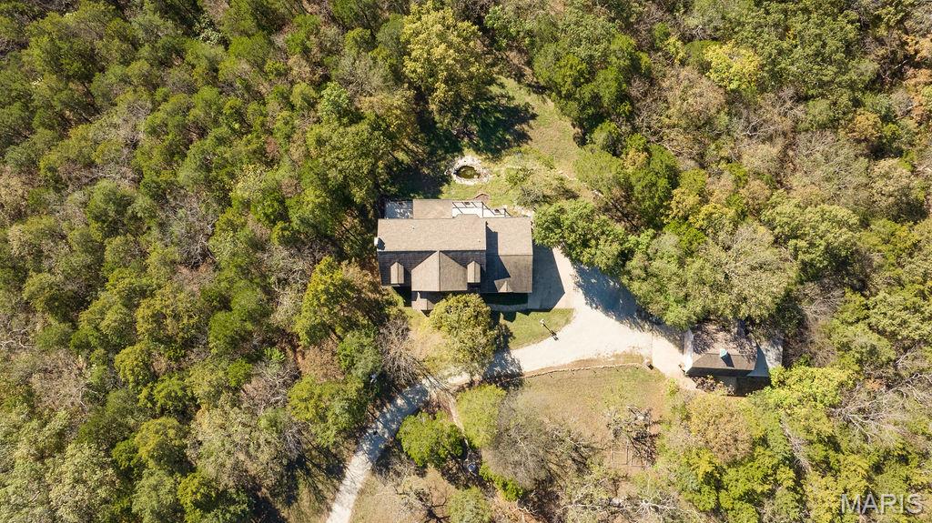 A Very Rare Opportunity — Nearly 14 Acres of Private Living
This extraordinary property offers the perfect blend of privacy, old world charm, elegance and endless potential. From the moment you arrive, the well-lit drive, tranquil fountains, and picturesque landscape set the tone for your true private sanctuary.
Walk into a dramatic two-story foyer and large open staircase, complemented by custom millwork, rich hardwood floors. Light and bright...this home features a large number of Palladian windows and bay windows that frame breathtaking views of the surrounding landscape. The open-concept kitchen and hearth room are designed for both everyday living and entertaining, featuring solid-surface countertops, a breakfast bar, a butler’s pantry, large center island and premium built-in Sub-Zero refrigerator, dishwasher, trash compactor and more. Hearth room features large stone fireplace and both rooms welcome you to step outside to the expansive, beautiful, low-maintenance deck and take in peaceful overlook views—an ideal space for morning coffee or evening gatherings. The primary suite is a true retreat, offering an extra-large bedroom, a spa-like bath with double vanities, a separate shower and soaking tub with a wonderful view, and a generous walk-in closet.

The finished lower level expands the living space with a large family room (also suitable as an additional bedroom), a full bath, large game room, and wet bar, all opening to a private, covered patio—perfect for indoor-outdoor entertaining. Basement also has and additional washer/dryer hook-up. 

Car enthusiasts and hobbyists will appreciate garage parking for five vehicles. Just steps away, a barn-style building with finished second-level space provides exceptional flexibility—ideal for conversion to a barndominium, office, studio, or hobby space... building also has an additional lean-to for outdoor equipment or 6th car...building is not included in the home’s square footage and offers endless possibilities. 

Solid property was completely Union built and also features 2 x 6 exterior walls plus electric has already been run to the property line for future electric gate installation (controlled by switch at front door). 
Move right in or update to your personal taste—either way, opportunities like this are seldom available. Privacy, views, acreage, and unmatched versatility come together in one remarkable estate.