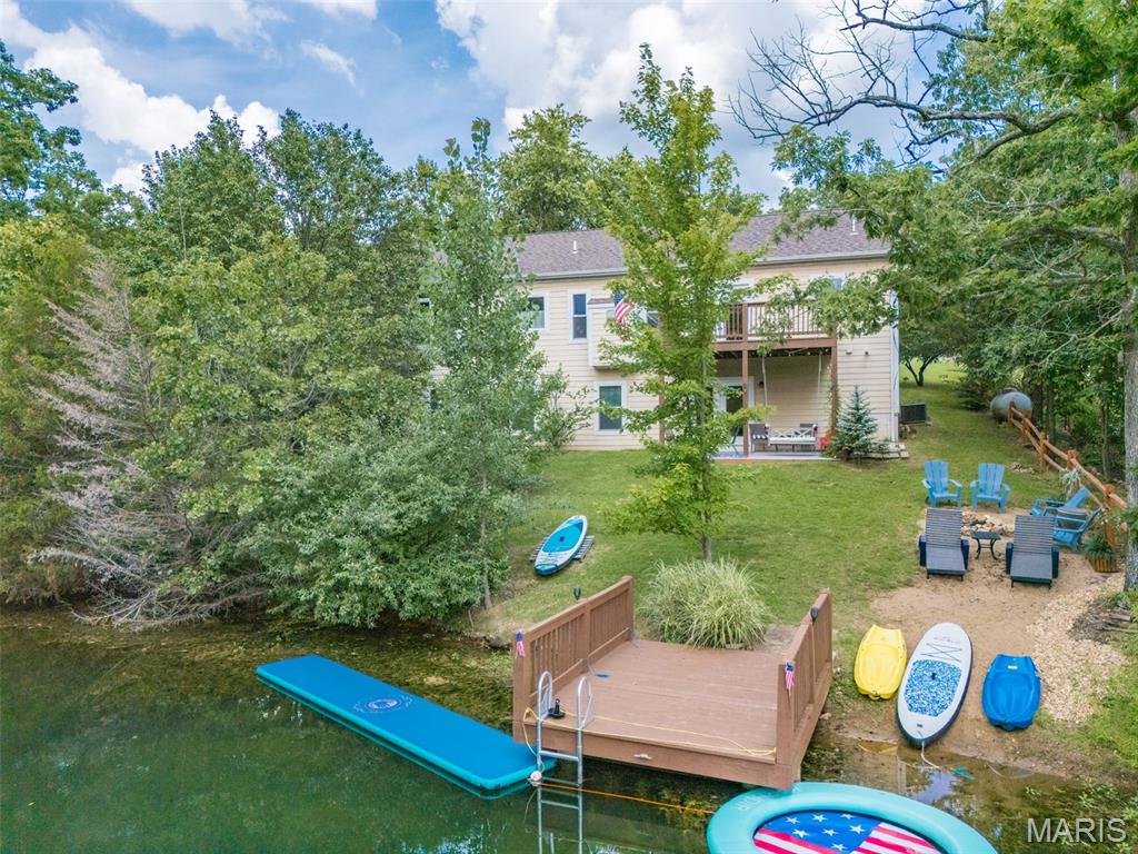 LAKEFRONT LIVING AT ITS BEST | Terre du Lac   Lake days. Sunset evenings. Memories that last a lifetime.
Tucked away in one of Terre du Lac’s most peaceful coves, this impeccably maintained lakefront retreat offers the perfect combination of relaxation, recreation, and investment potential.  Wake up to serene lake views, enjoy your morning coffee overlooking the water, then spend the day paddleboarding, swimming, fishing, or simply floating in the calm, crystal-clear cove. With a deep-water private dock, you’ll enjoy some of the best waterfront living Terre du Lac has to offer.  Designed for entertaining and hosting, this spacious home features 5 bedrooms, 3 full bathrooms, and the rare convenience of both upstairs and downstairs kitchens and living areas—ideal for large families, multi-generational living, weekend guests, or vacation long-term rental flexibility.  The private owner’s suite provides a peaceful escape, while the thoughtfully designed floor plan offers room for everyone to spread out and enjoy.   Whether you’re looking for your forever lake home, a luxurious weekend getaway, or an investment property that can begin generating income immediately, this home offers opportunities that rarely come available.  Basic turnkey and ready for you to just bring your close and enjoy the Lake Life.  Accepting all offers until Wednesday July 16th.