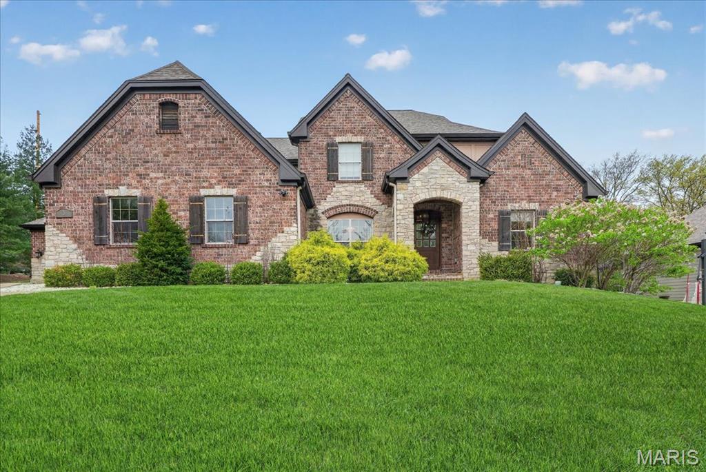 A refined expression of modern living, this 11-year-young residence offers the ease of a true lock-and-leave lifestyle without compromising scale or sophistication. Ideally positioned within the Ladue School District, just moments from premier schools, major thoroughfares, and the area’s finest shopping and dining, the home delivers exceptional convenience for today’s dynamic lifestyle. The light-filled interior is defined by a flexible, thoughtfully designed floor plan. Architectural details—including hand-scraped hardwood floors, soaring 9’+ ceilings, and graceful curved wall construction—create a sense of thoughtful design throughout. The vaulted great room centers around a striking double-sided gas fireplace with stone surround, offering a seamless transition between formal and casual living spaces. The eat-in kitchen is designed for both everyday ease and elevated entertaining, featuring a large island, top-tier stainless steel appliances and a natural flow to the butler’s pantry, breakfast room, and hearth room. The main-level primary suite serves as a private retreat, complete with a generous walk-through closet and a spa-inspired bath with dual vanities, soaking tub and separate shower. A secondary main-floor suite provides versatility for guests, a home office, or multigenerational living. Upstairs, three ensuite bedrooms are complemented by an expansive family room or media lounge. The lower level offers a finished recreation space with ample opportunity for customization, while three-car garages, mudroom, and dedicated main-floor laundry enhance everyday functionality. A rare opportunity to own a newer, low-maintenance home in one of St. Louis’ most sought-after locations—where luxury, convenience, and effortless living align.