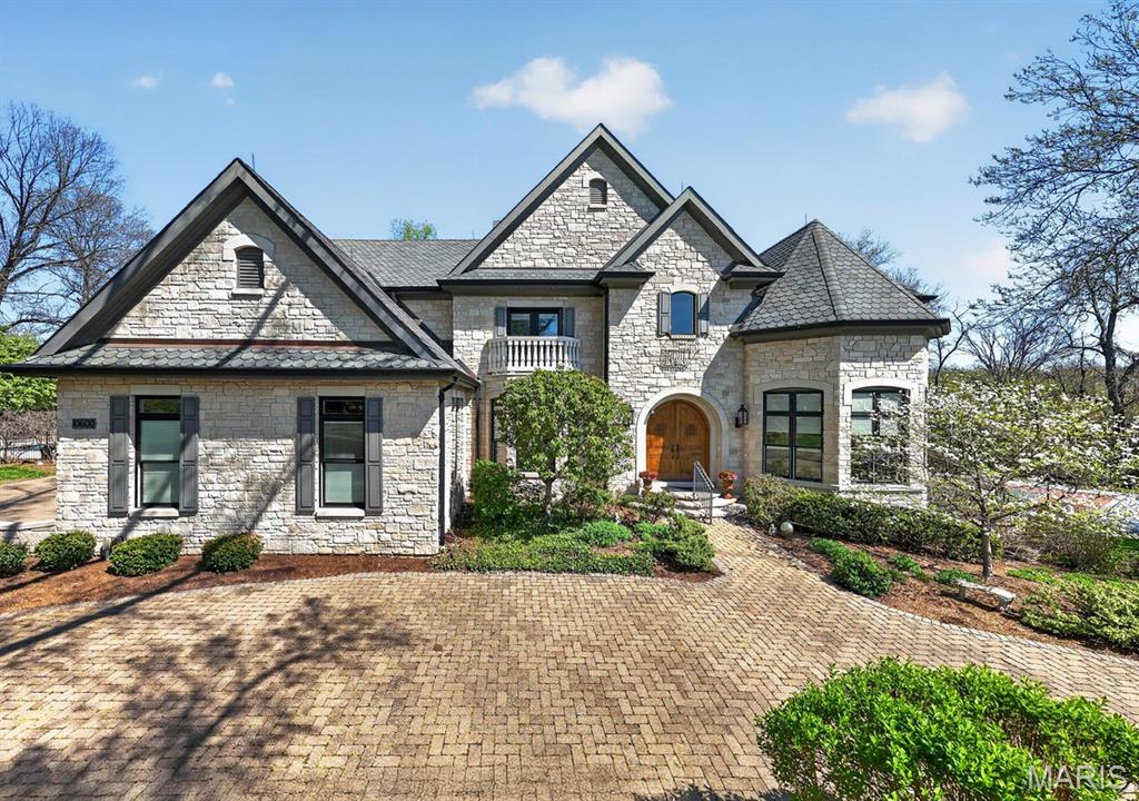This extraordinary custom home has been handcrafted with endless amenities to include a private beautiful inground saltwater pool and sport court.  Very private setting at the end of a cul-de-sac and next to neighborhood park.  Private screened porch with patio backing to trees.  This home has so much to offer and really is one of a kind.  Ladue Schools and walking distance to Spoede Elementary.  Formal octagon office with built in bookcases, wood flooring, and heavy millwork.  Large dining room with coffered ceiling and wood floors.  Two story great room with gas fireplace, wet bar and wood flooring.  Huge kitchen with large center island that opens to the attached family room and breakfast room area.  Wood floors, stone accent wall, gas fireplace, Decor stainless appliances, crushed recycled glass counter tops, views to the rear and side overlooking garden patio and in ground pool.  First floor master bedroom with fireplace and in-suite luxury master bath.  Dual vanities, separate shower and tub, crushed recycled glass countertops.  Upstairs 3 expansive bedrooms each with their own bath and walk in closet.  A second laundry is located on the second floor as well. The lower level is finished with large rec room, family room, walk behind full bar, wine cellar that holds approx 1,000 bottles, full bath, half bath, exercise room and gas fireplace.  Walk out to lower-level patio/yard and sport court.  Great curb appeal with custom wood front door and circle drive.  3 car garage is heated. Newer roof.  Geothermal heating and cooling. Truly a remarkable home with much to offer!